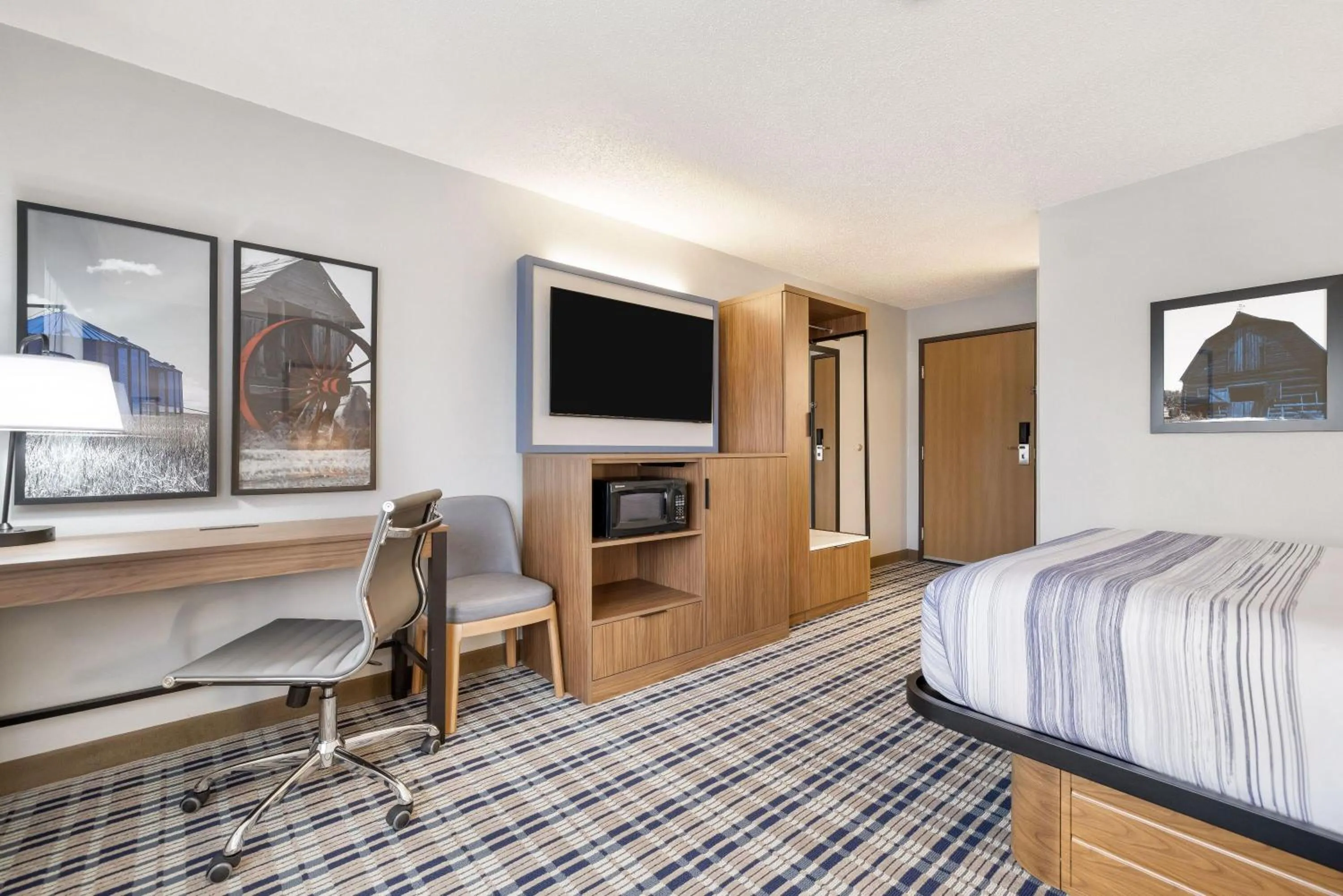 Bed in AmericInn by Wyndham Bismarck