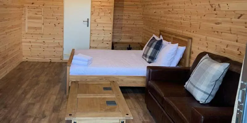 Bed in Superior Glamping Pod with Hot Tub