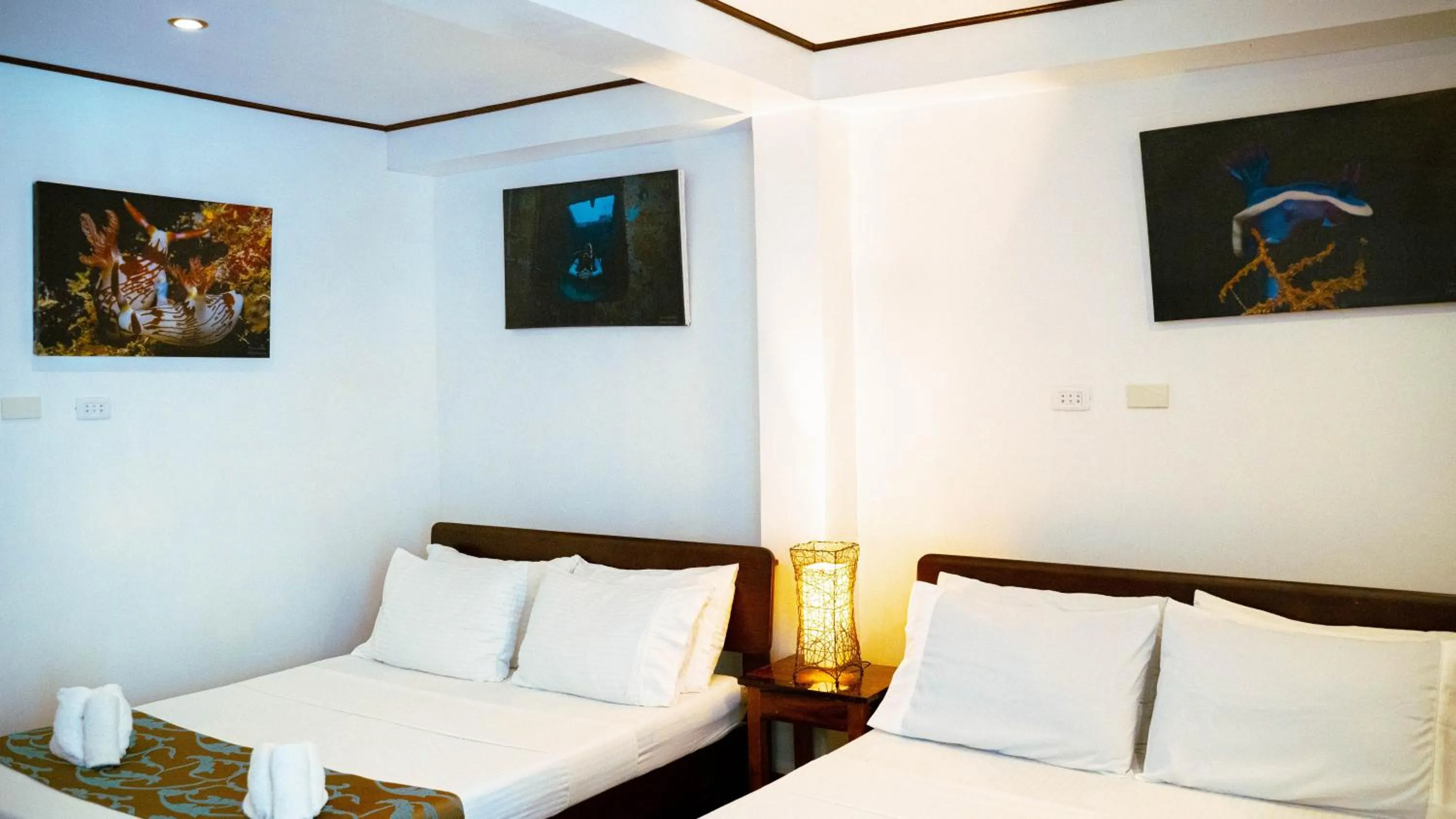 Bed in DiveGurus Boracay Beach Resort