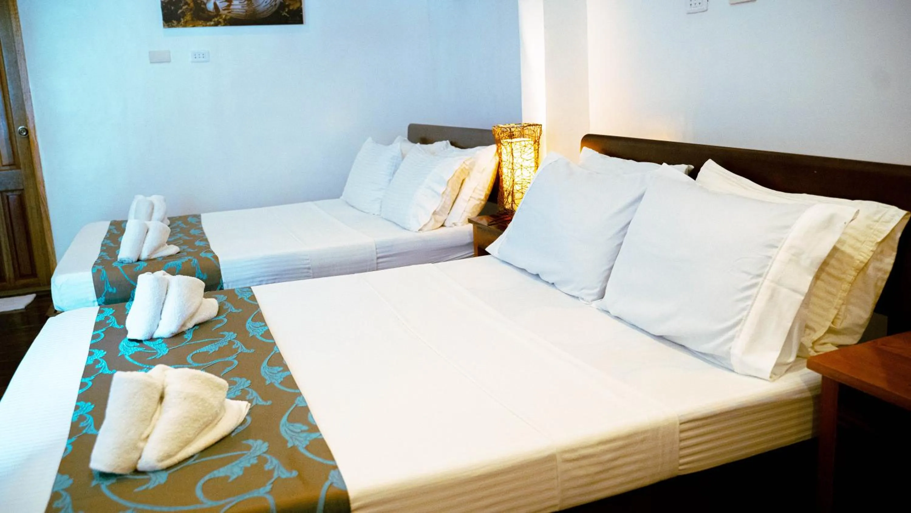 Bed in DiveGurus Boracay Beach Resort