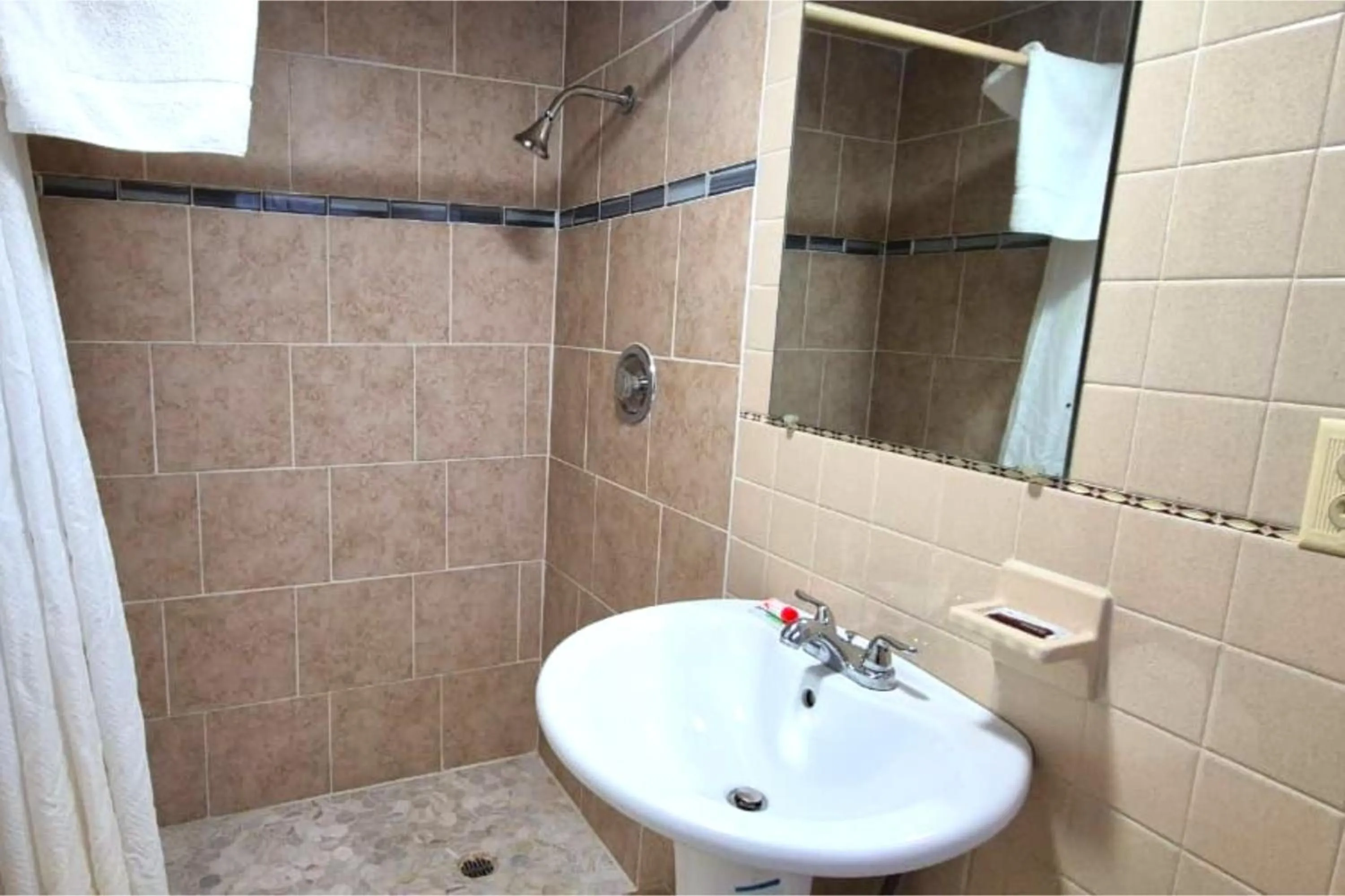 Bathroom in Economy Inn Cadillac MI by Hotel O