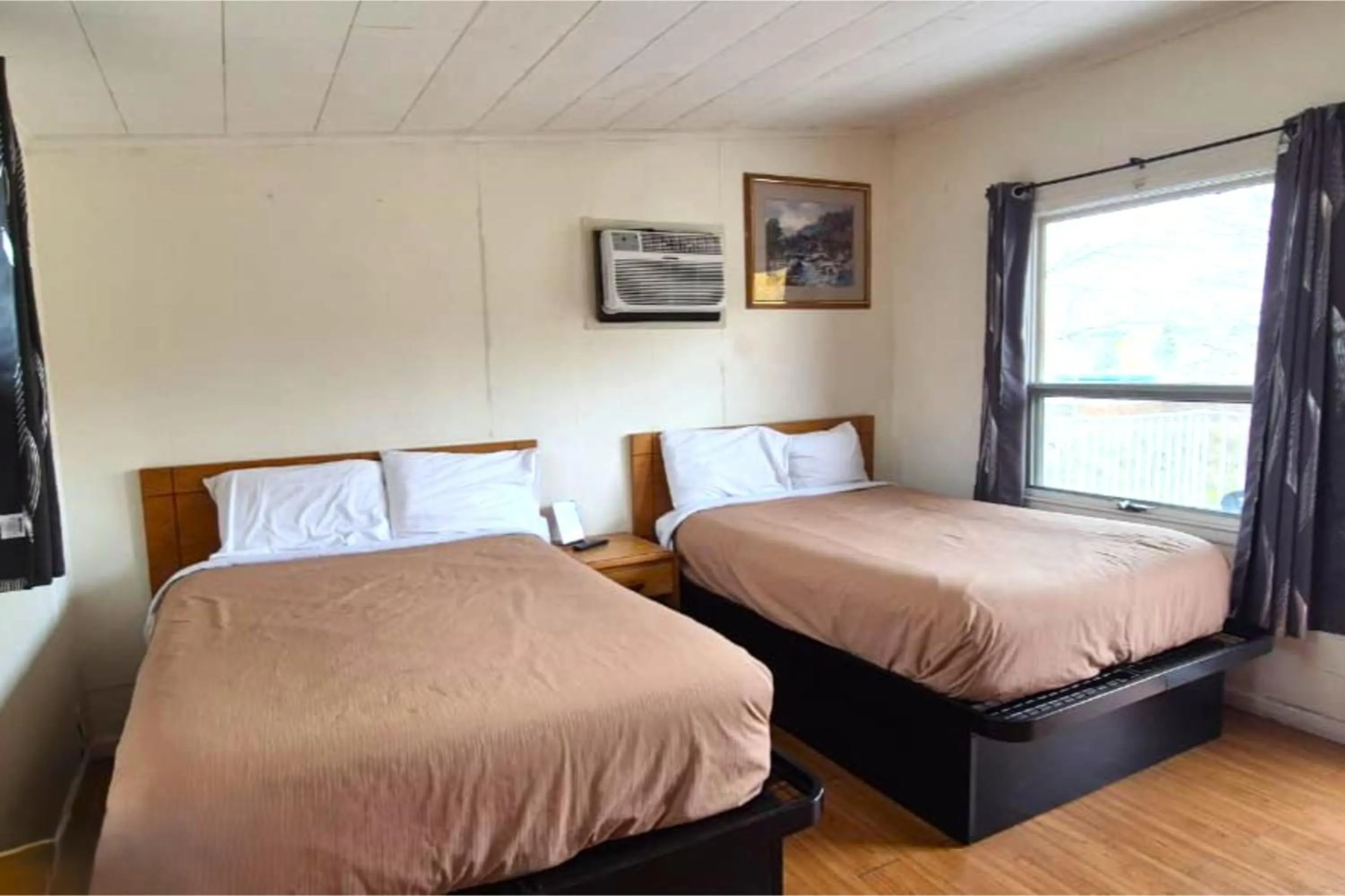 Bedroom, Bed in Economy Inn Cadillac MI by Hotel O