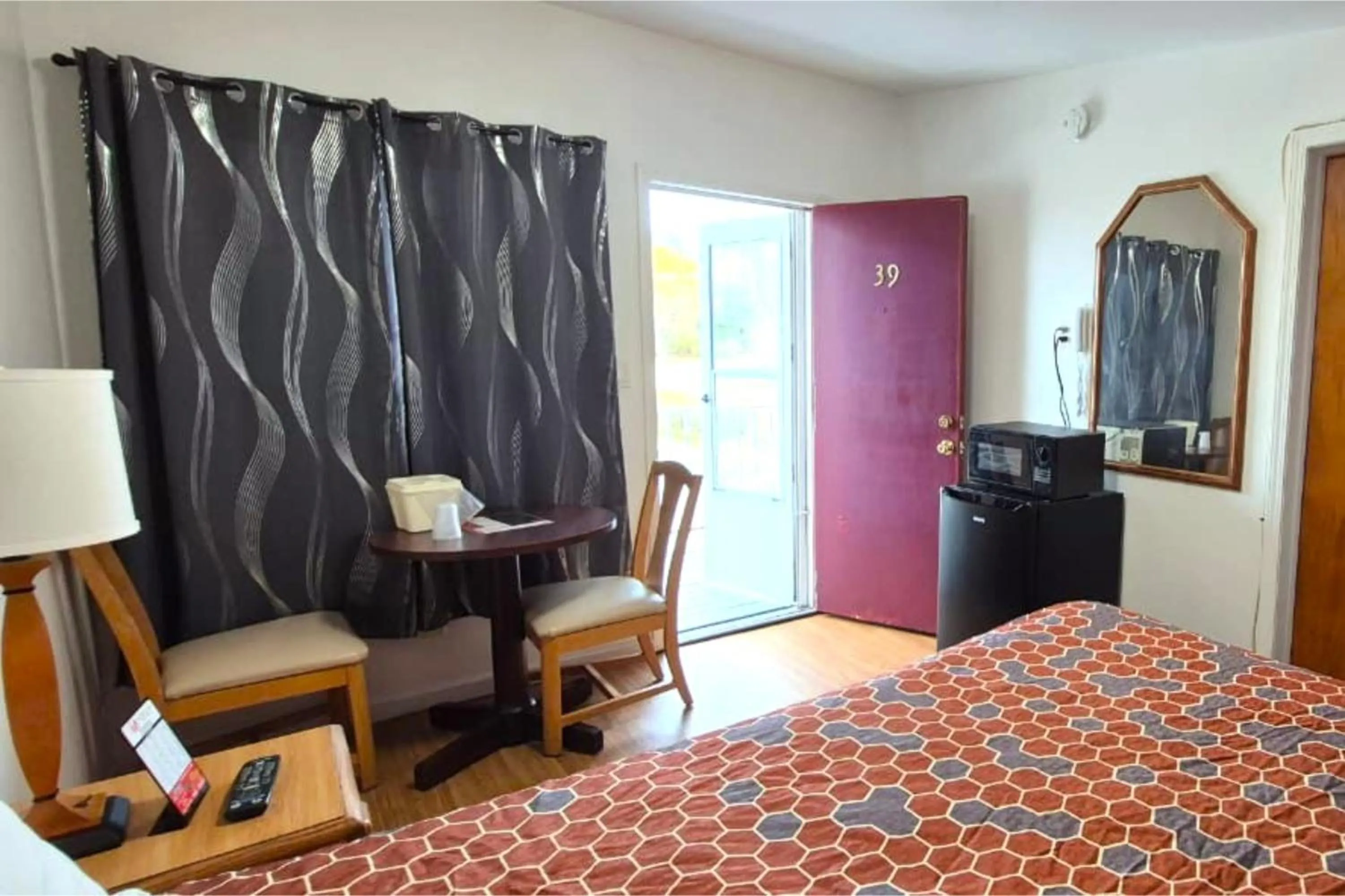 Bedroom, Bed in Economy Inn Cadillac MI by Hotel O