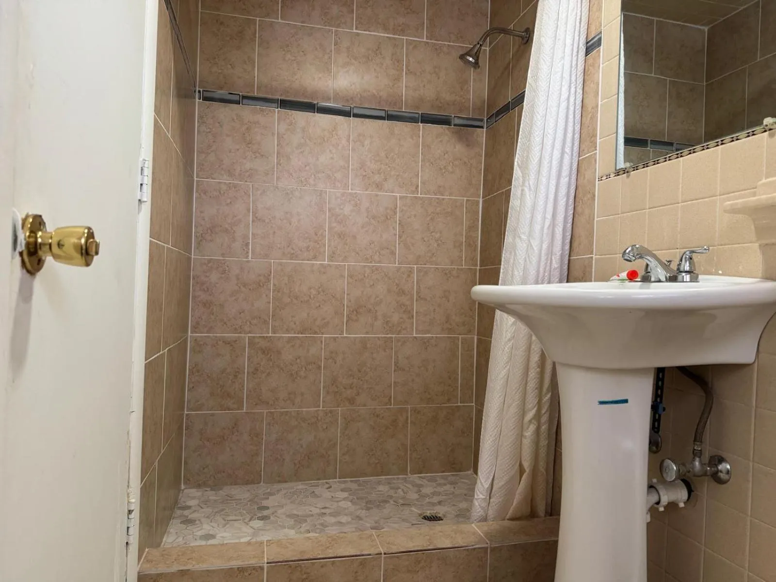 Bathroom in Economy Inn Cadillac MI by Hotel O