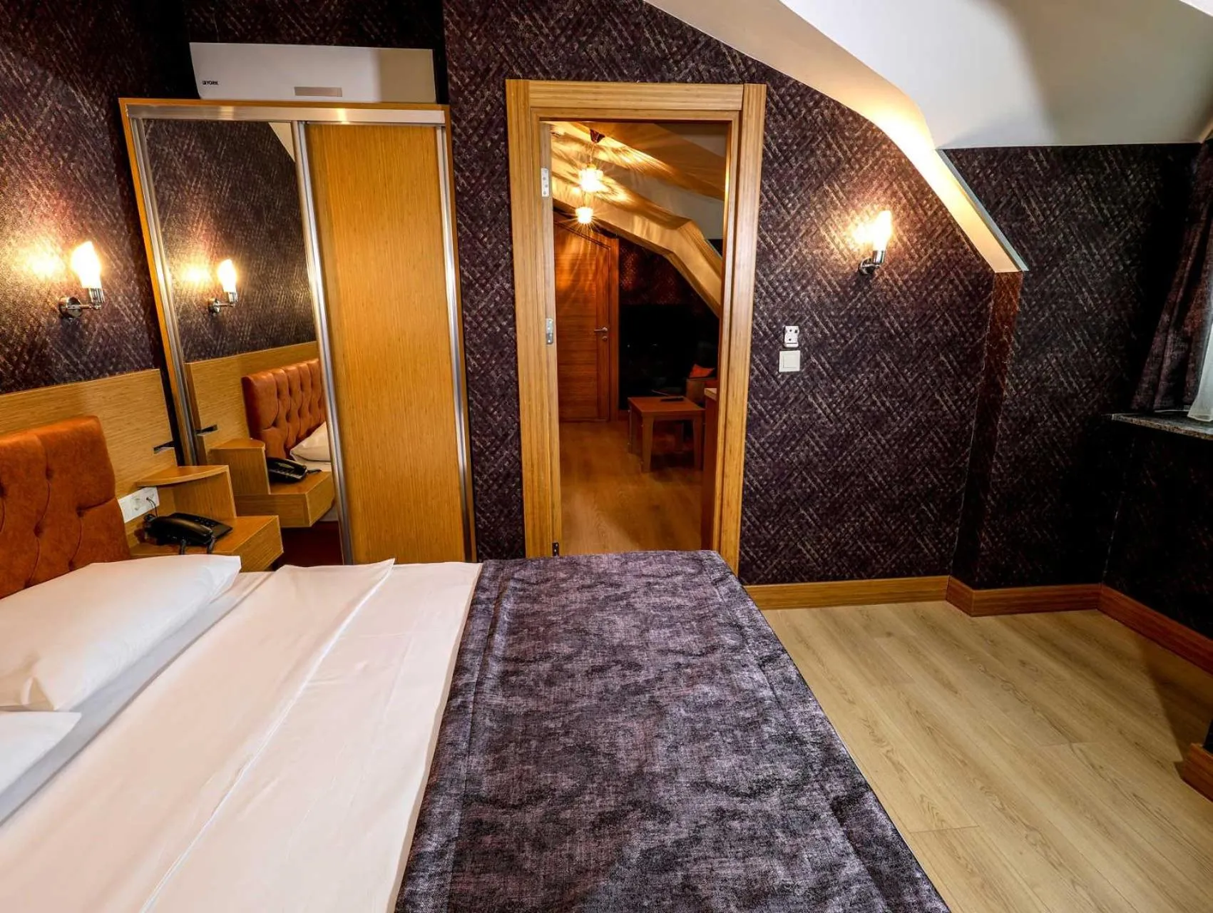 Bed in Grand Elmira Suites