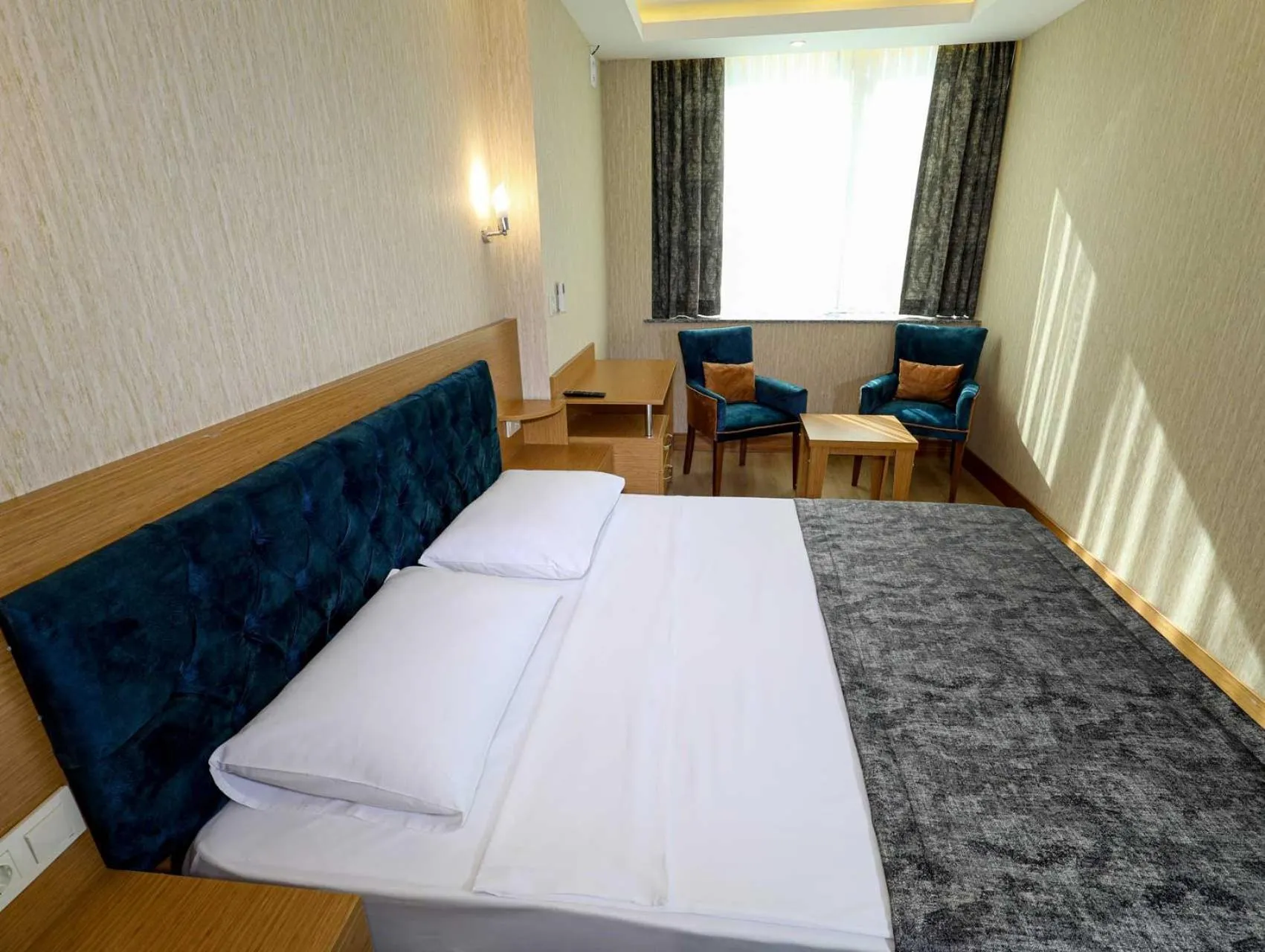 Bed in Grand Elmira Suites