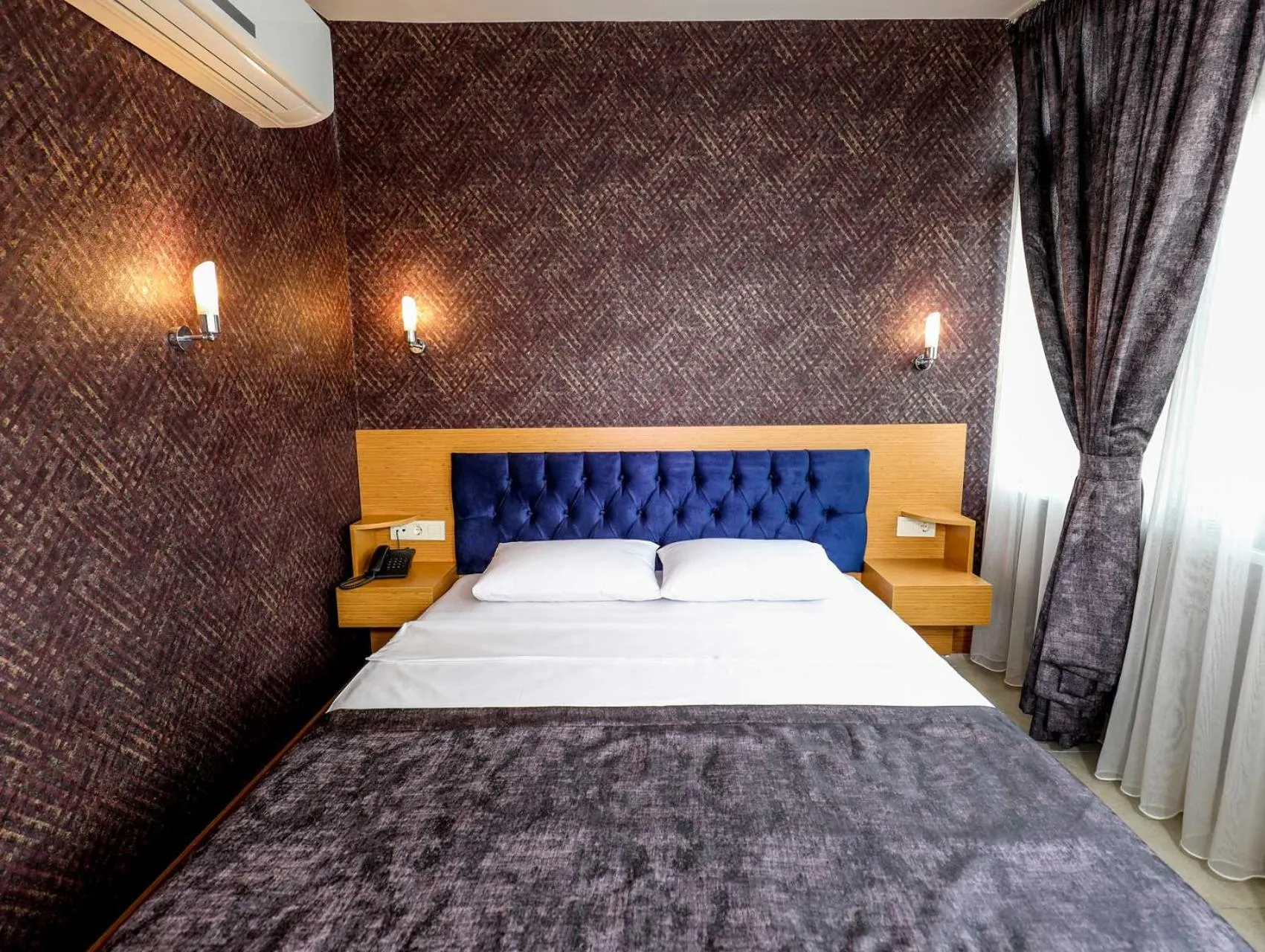 Bed in Grand Elmira Suites