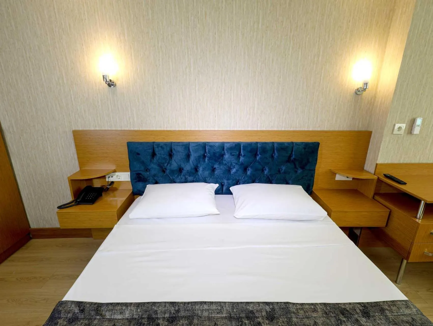 Bed in Grand Elmira Suites