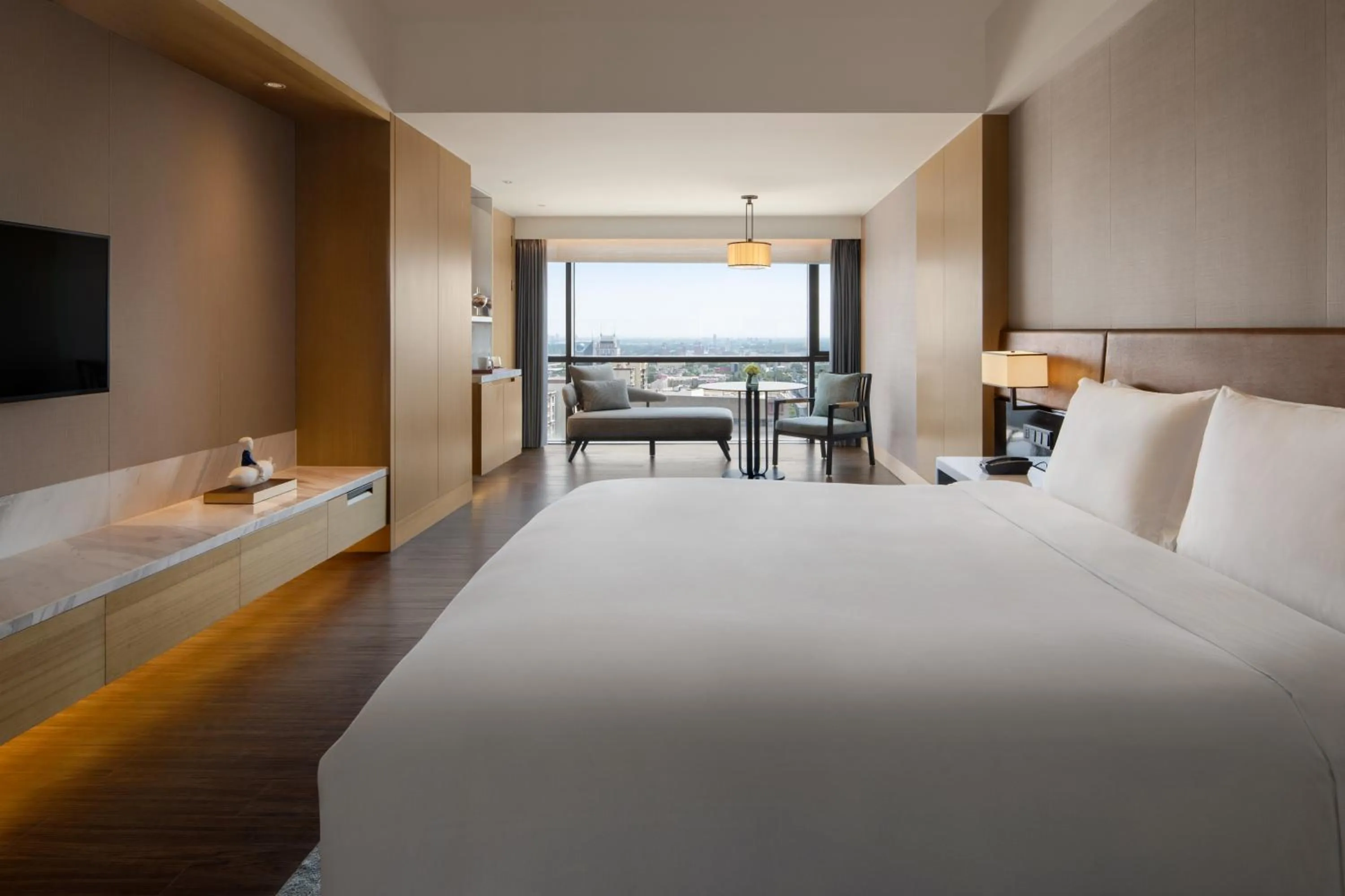 Bed in New World Langfang Hotel