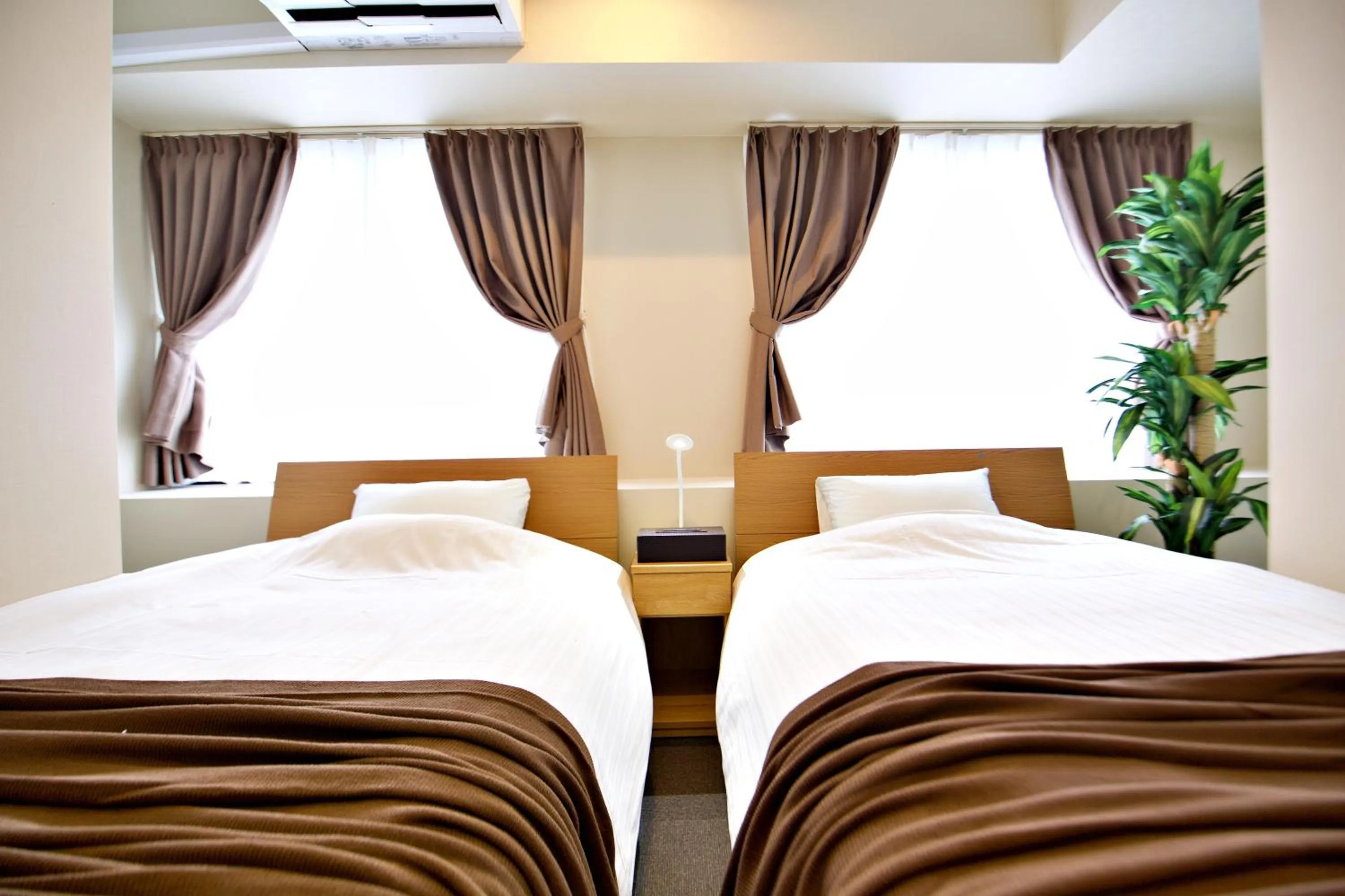 Bed in KURA HOTEL IZUMISANO