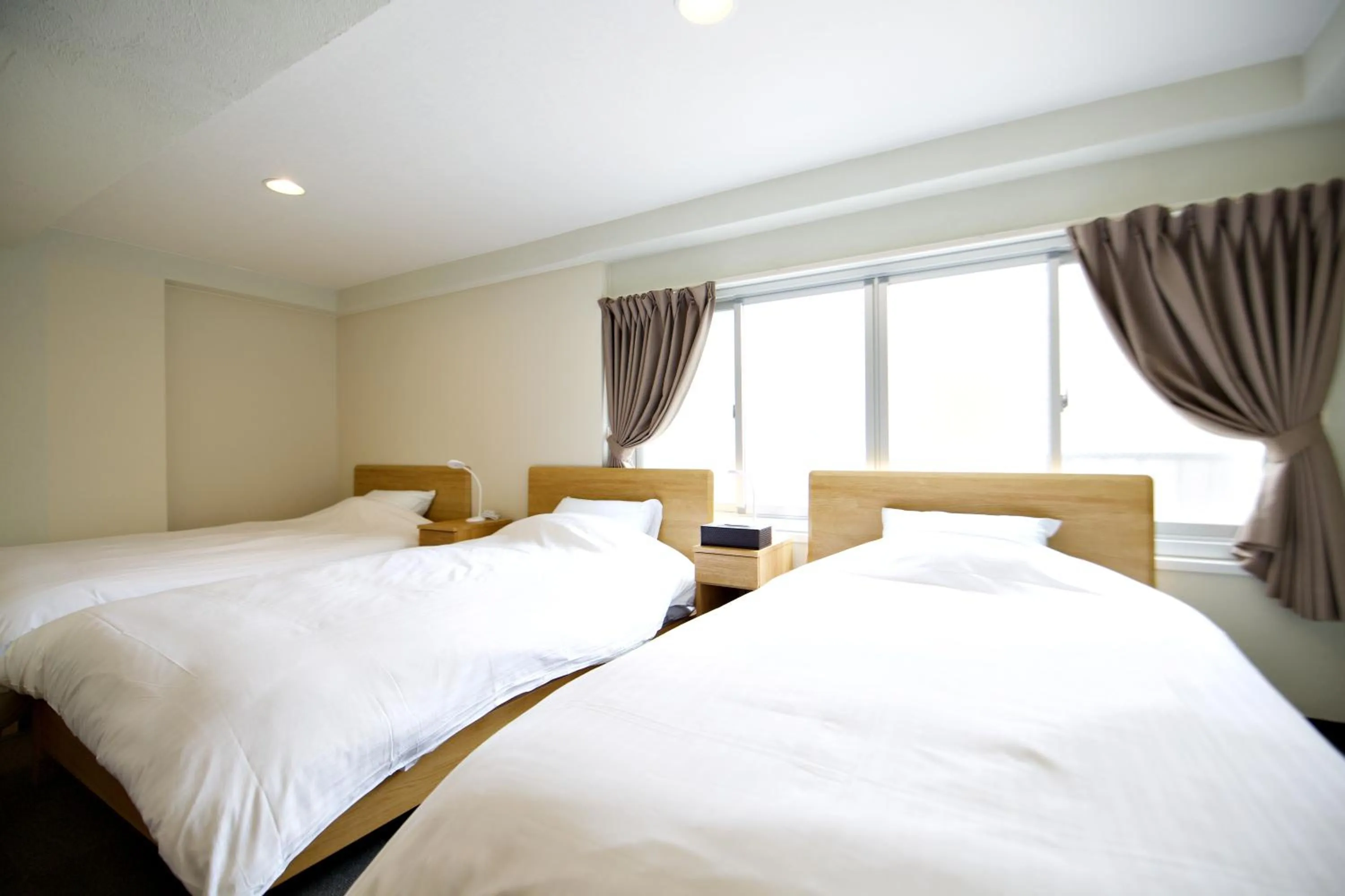 Bed in KURA HOTEL IZUMISANO