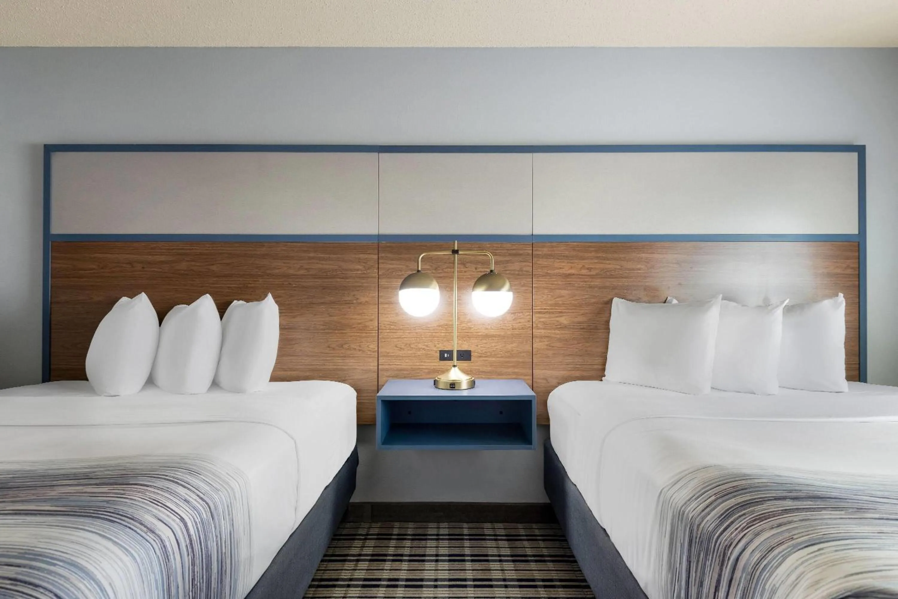 Bed in AmericInn by Wyndham Chamberlain Conference Center