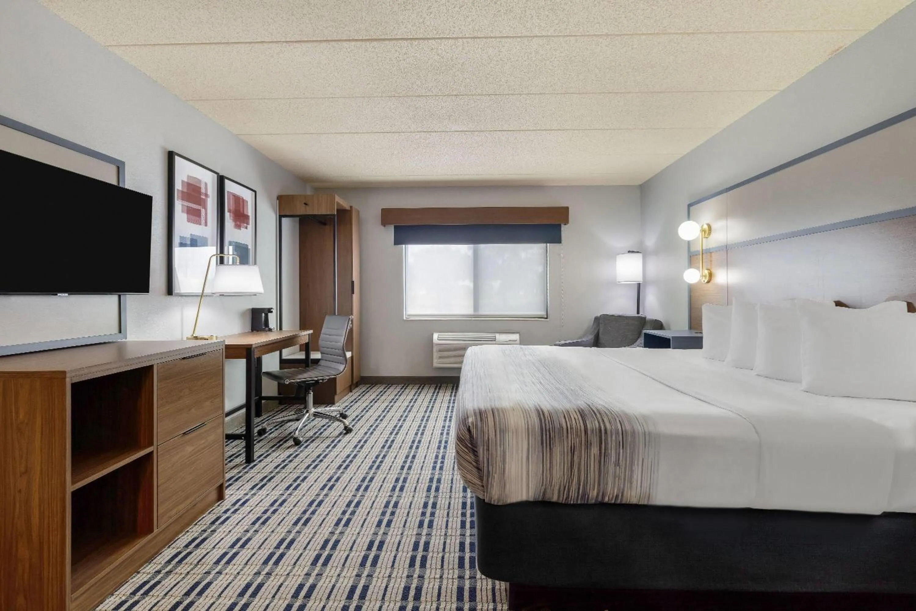 Bed in AmericInn by Wyndham Chamberlain Conference Center