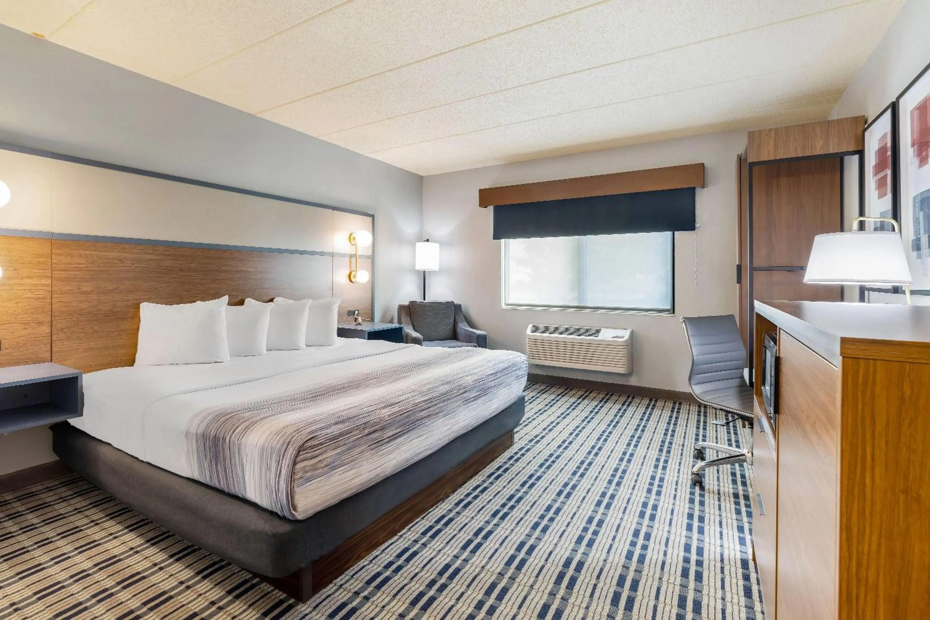 Bed in AmericInn by Wyndham Chamberlain Conference Center