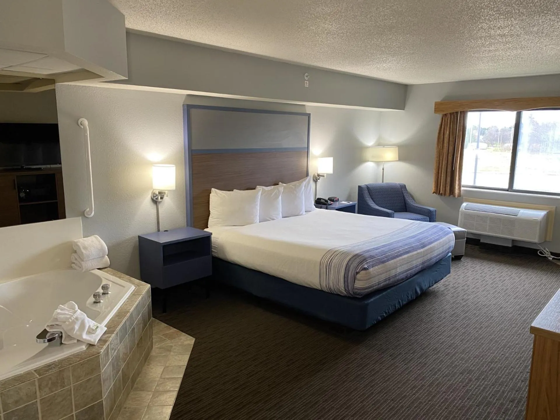 Bed in AmericInn by Wyndham Greenville