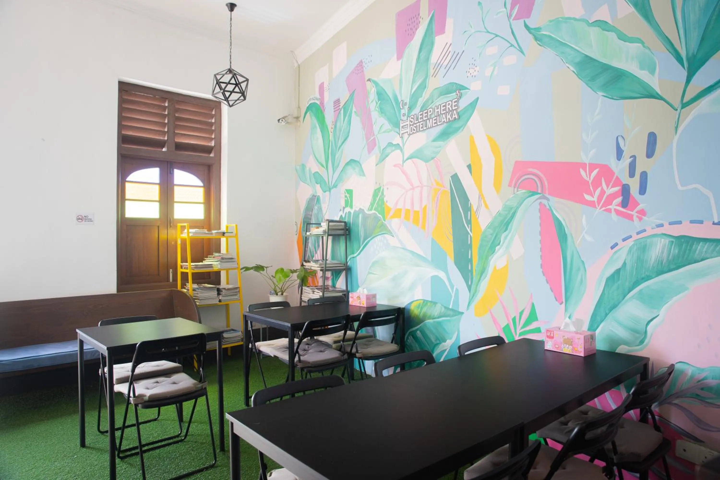 Communal lounge/ TV room in Sleep Here Hostel, Melaka