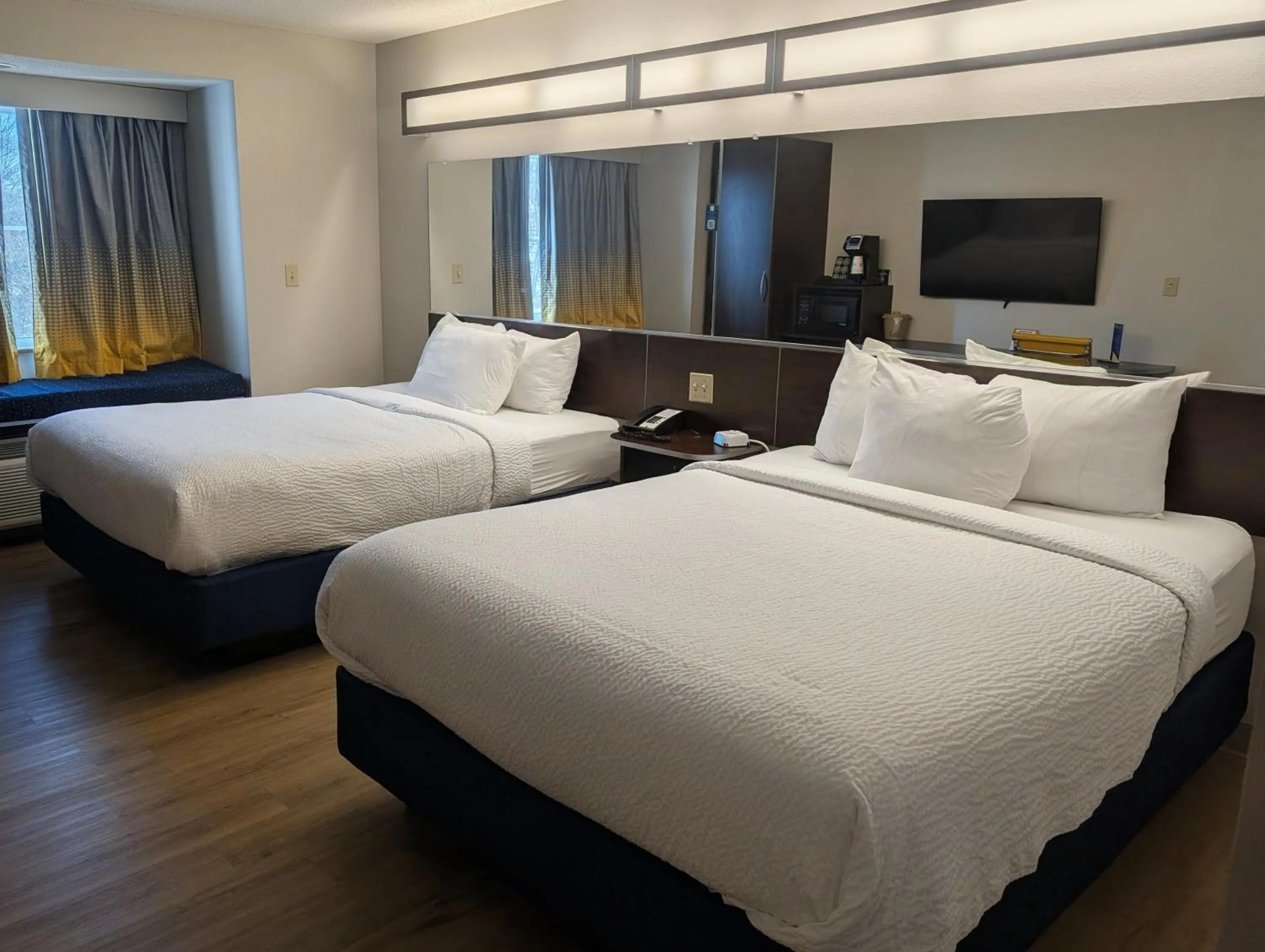 Bed in Microtel Inn & Suites by Wyndham Wheeling at The Highlands