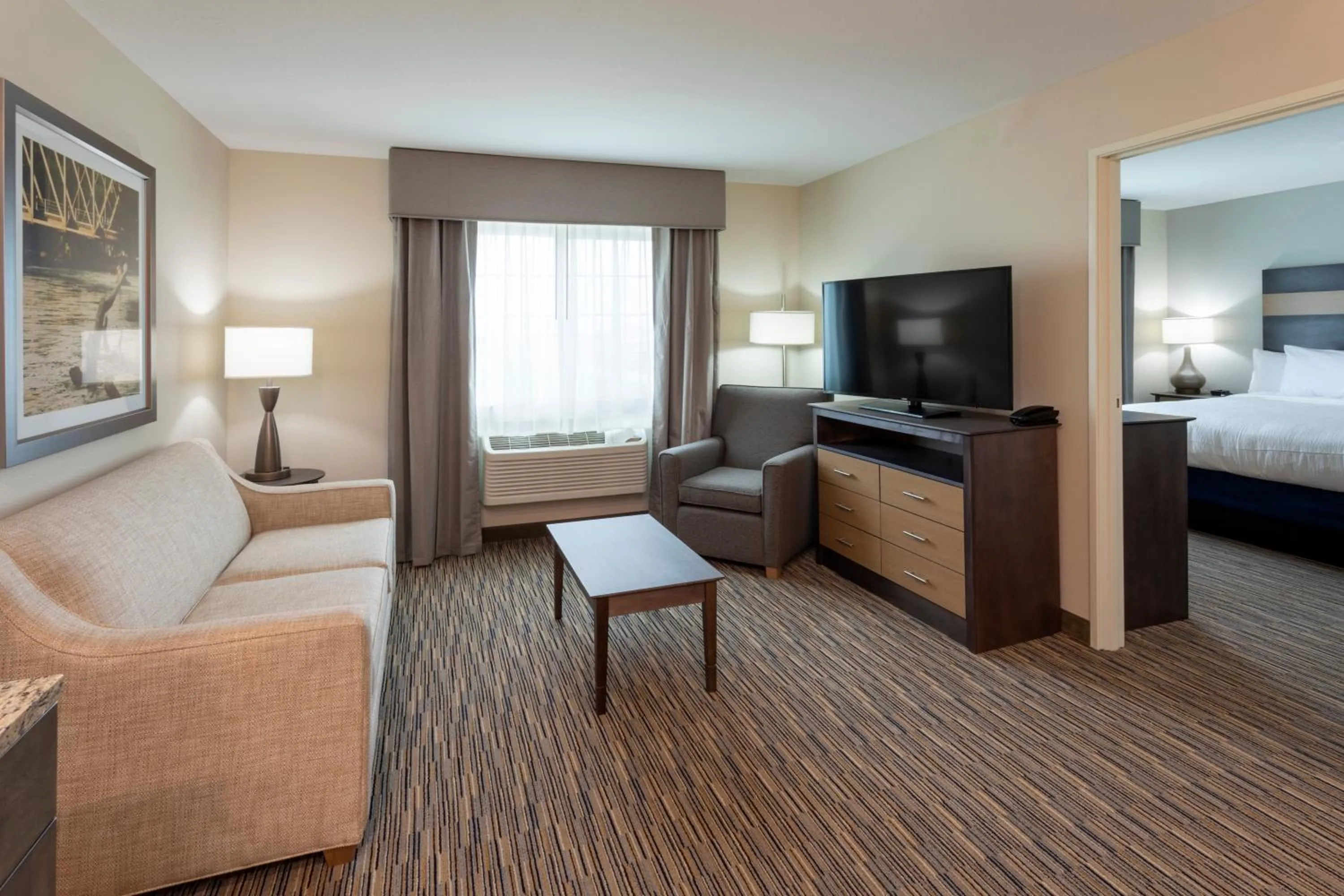 Living room, Bed in GrandStay Hotel & Suites Rock Valley