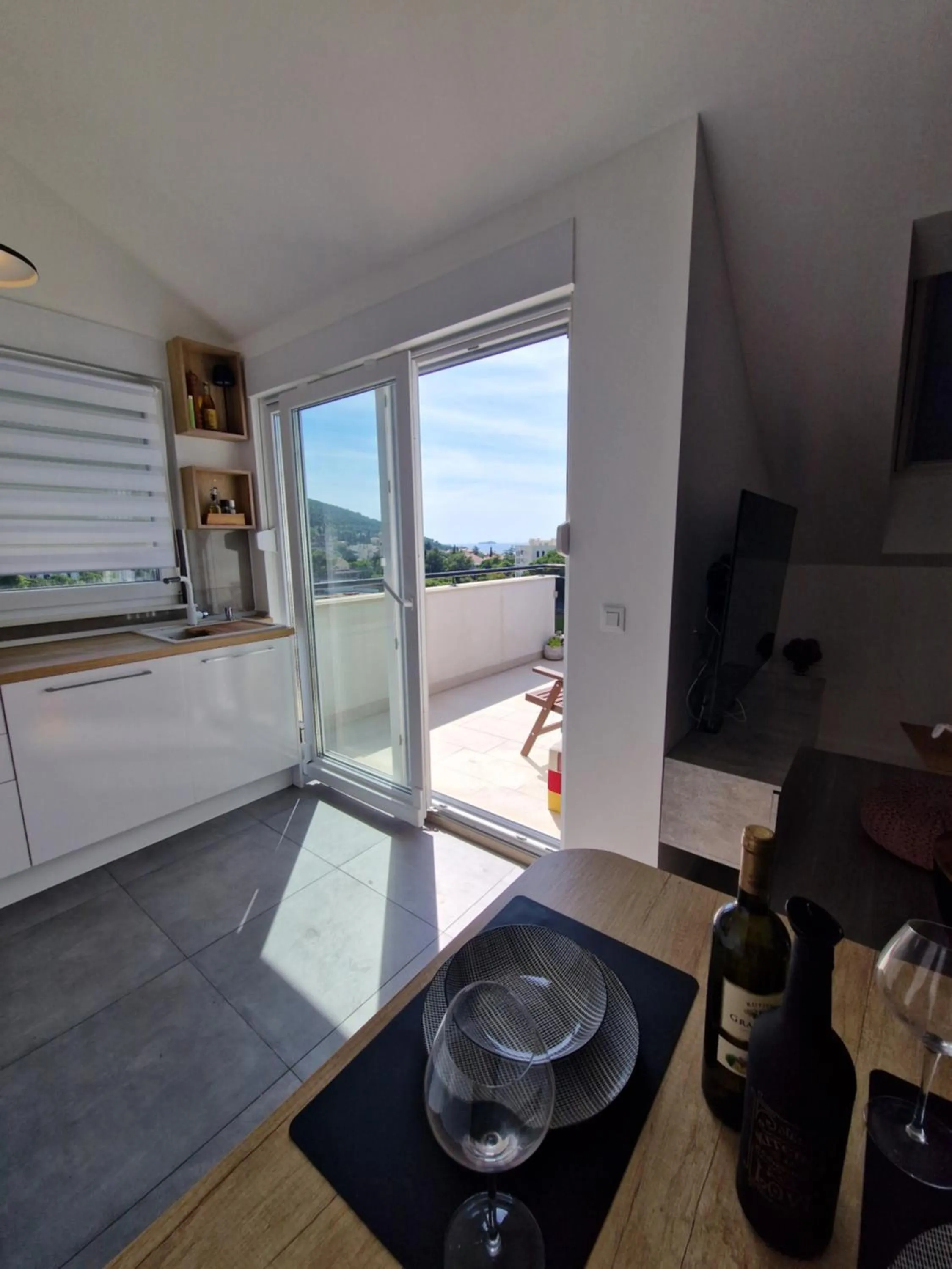 Dining area in Apartments Mak & Lux - sea & sunset top view