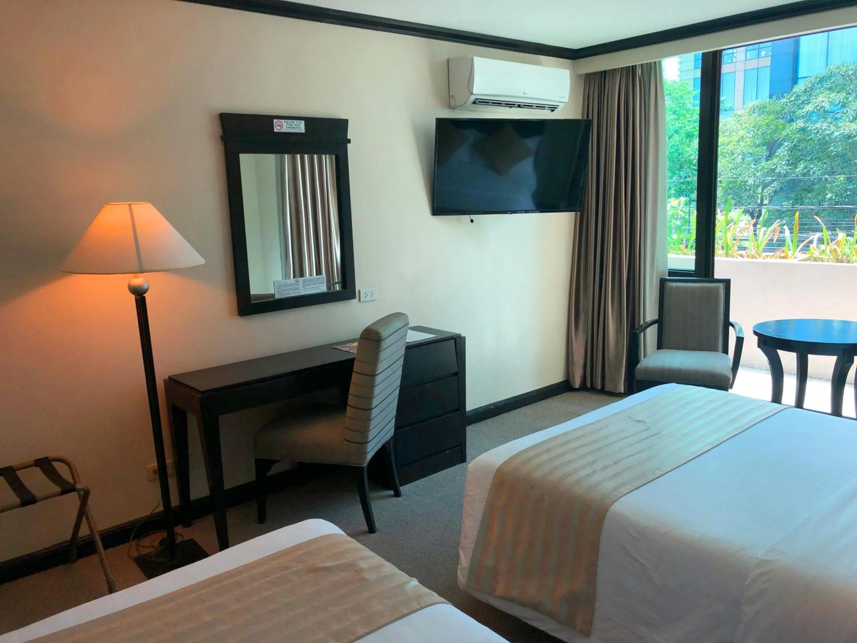 Communal lounge/ TV room, Bed in Tower Inn Makati Business Hotel