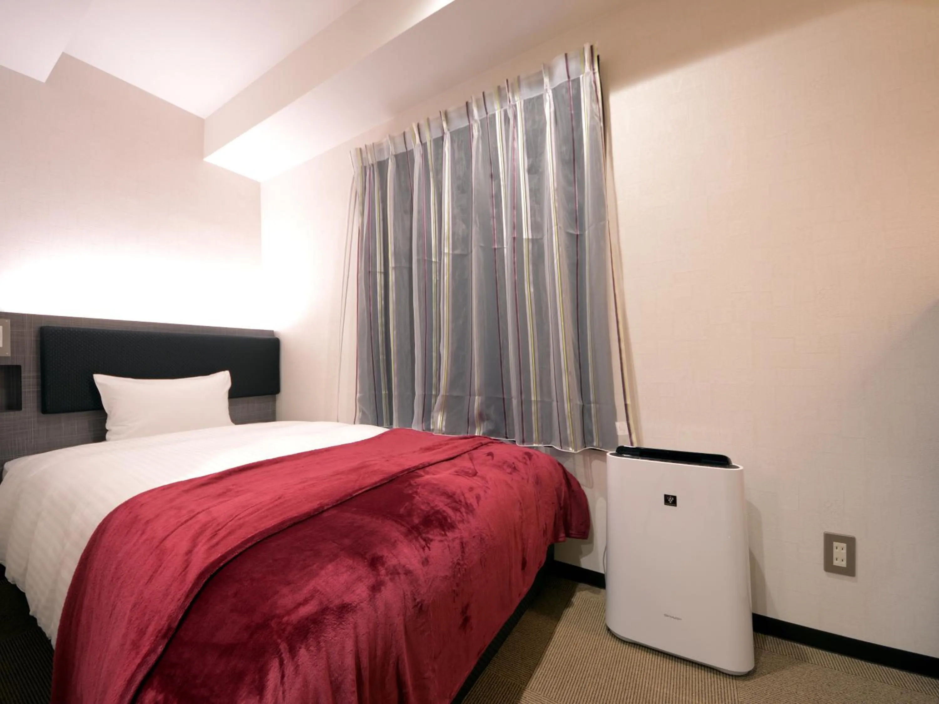 Bed in Green Rich Hotel Tottori Ekimae (Artificial hot spring Futamata Yunohana)