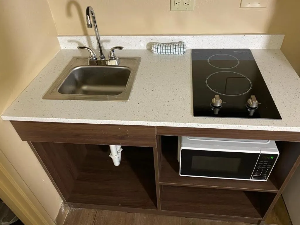 Kitchen or kitchenette in Suburban Studios Winston-Salem near Hanes Mall