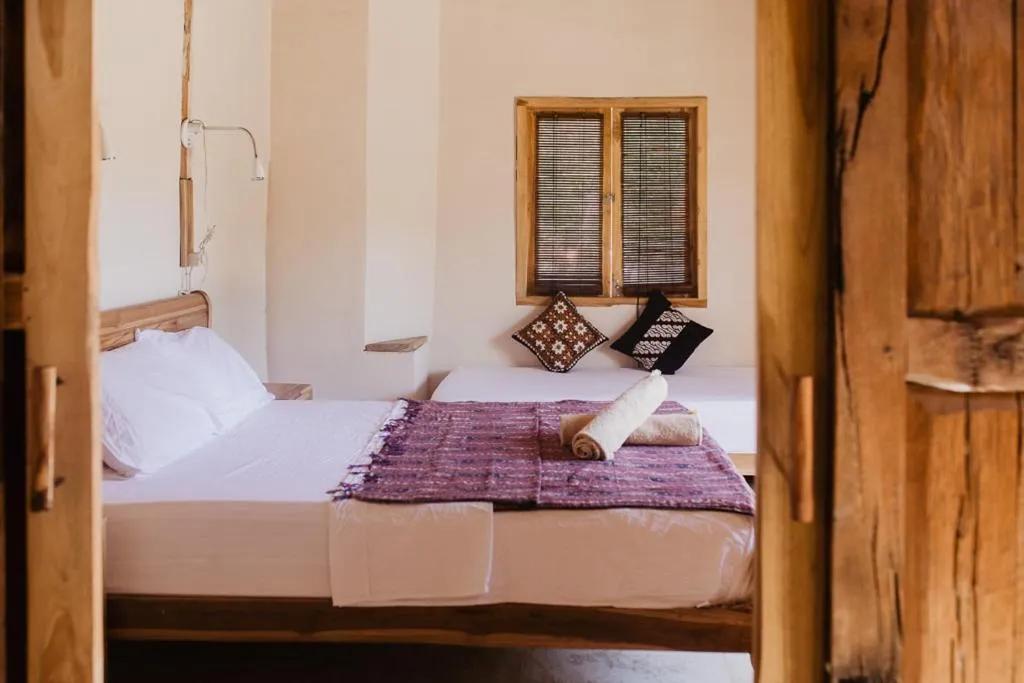 Bed in Kalyssa Beach Bungalows