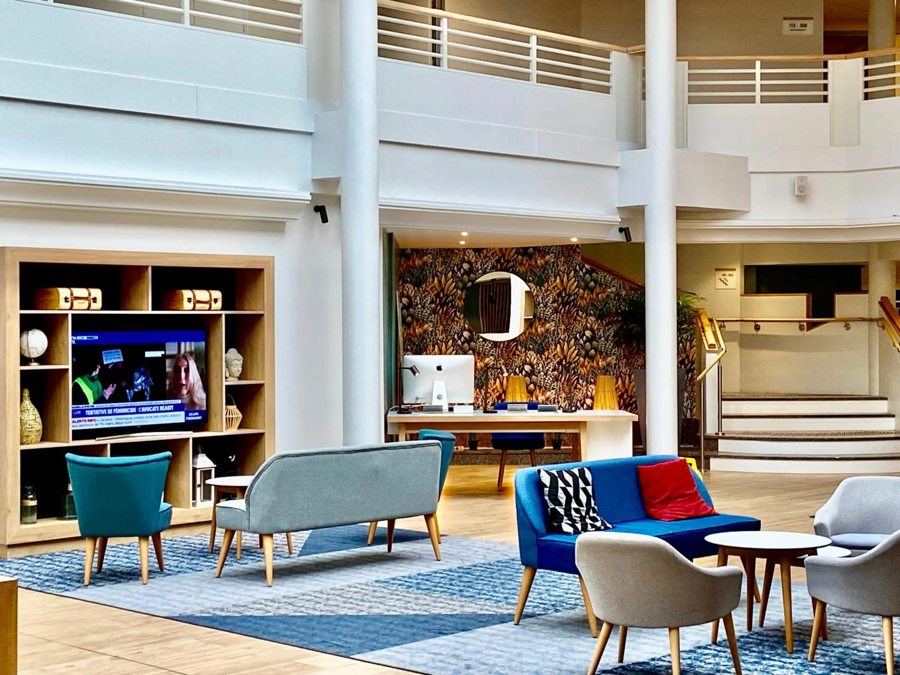 Communal lounge/ TV room in Holiday Inn Calais Coquelles by IHG