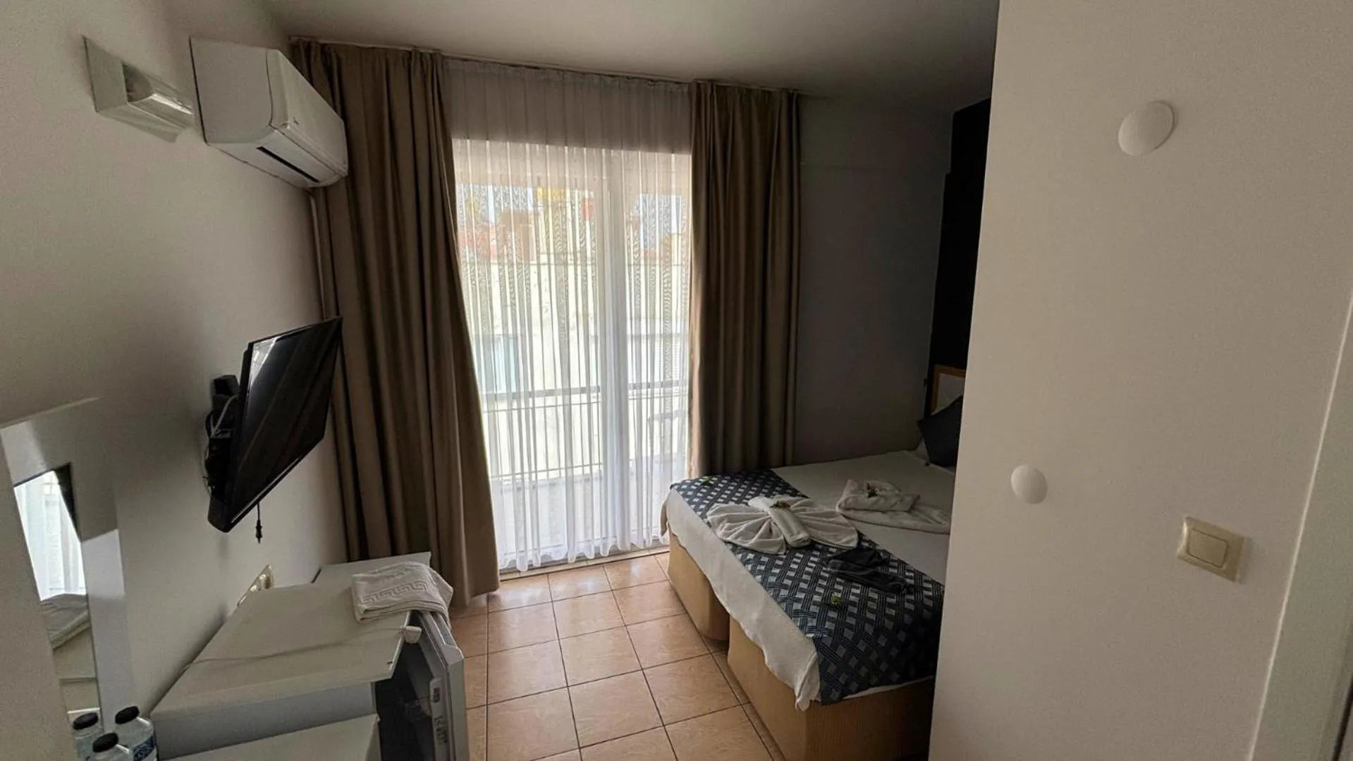 Bed in MOONBOW BEACH HOTEL