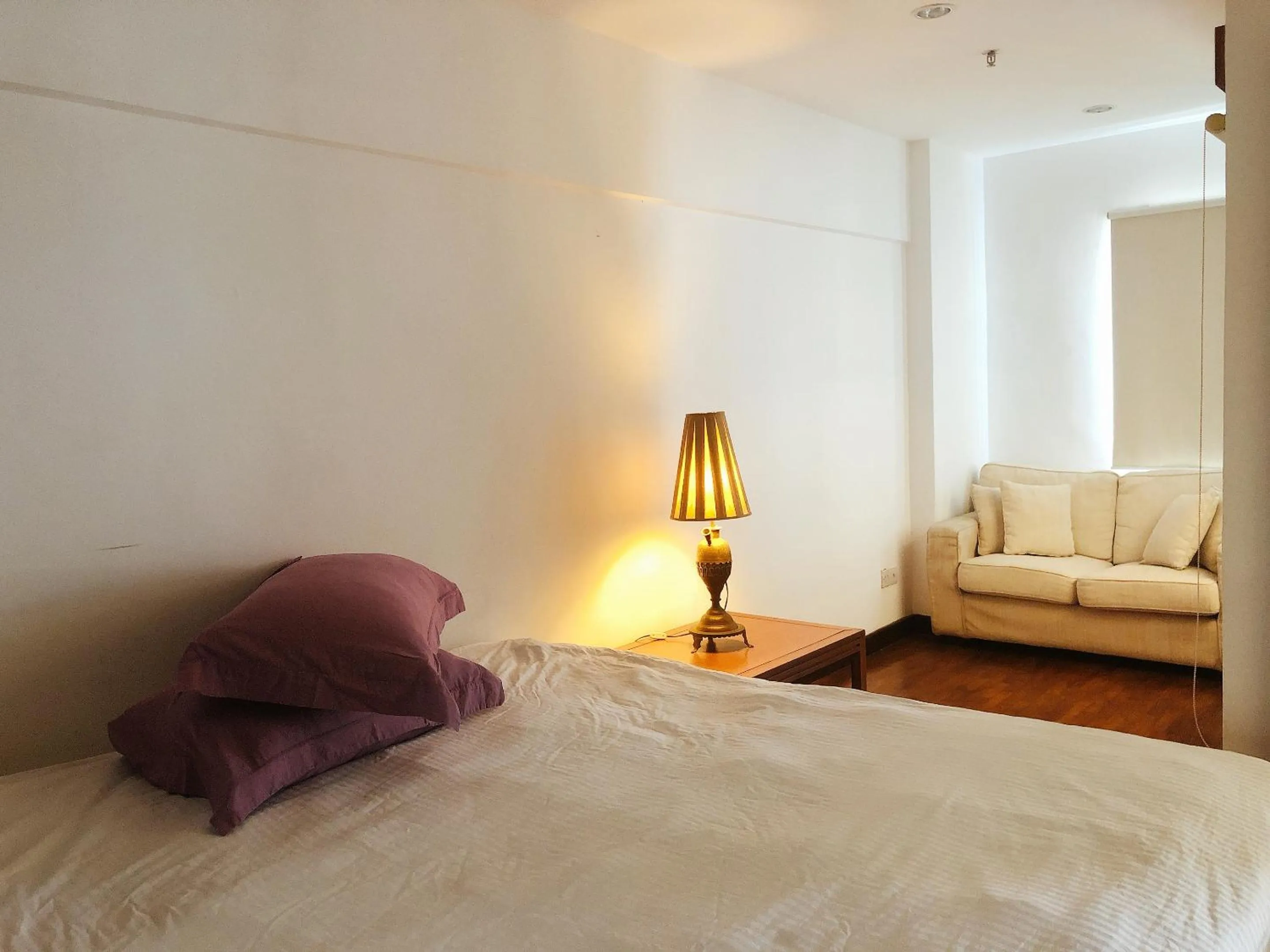 Bed in Peninsula Residence All Suite Hotel