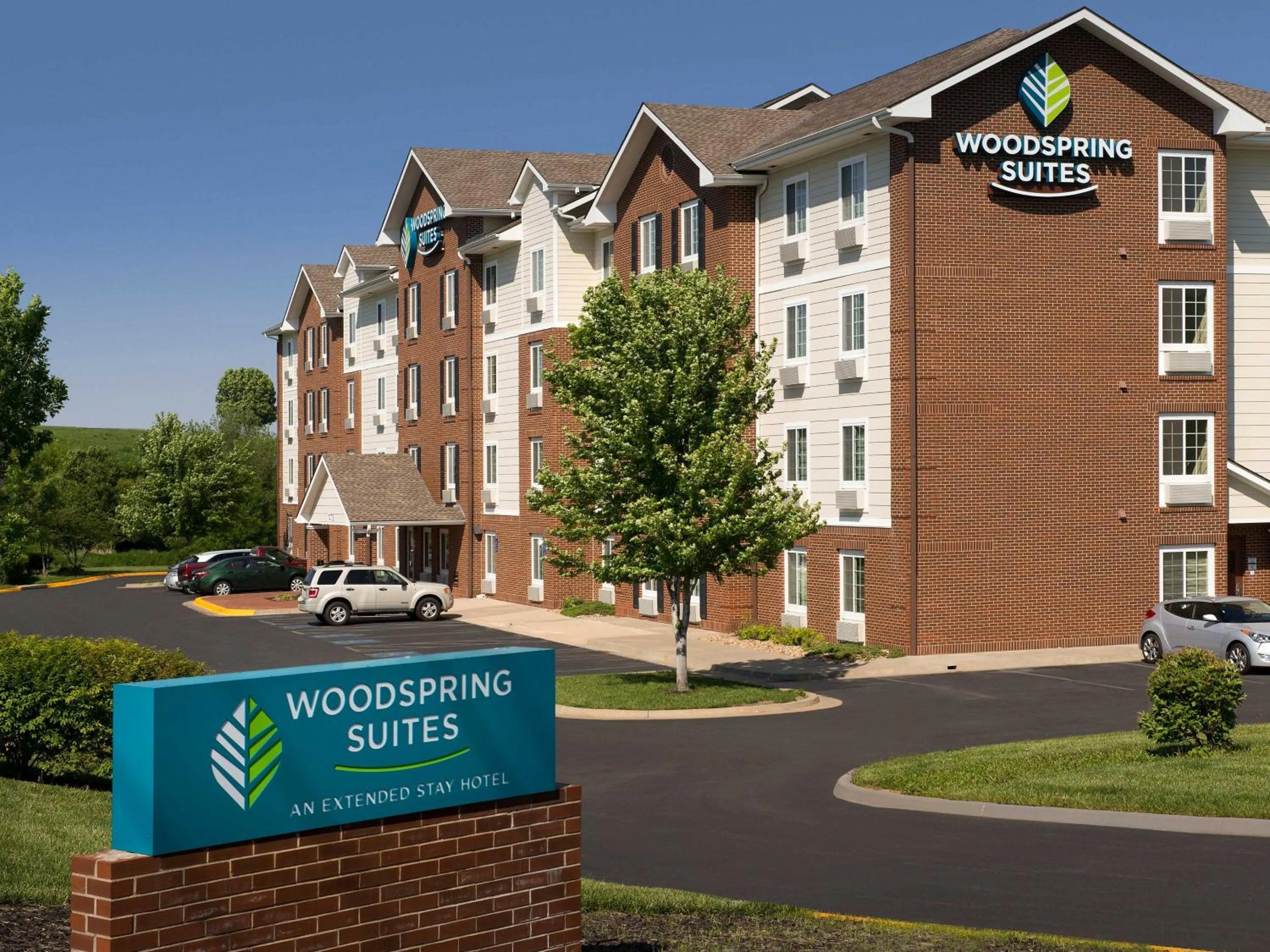 Property logo or sign in WoodSpring Suites Kansas City Lenexa