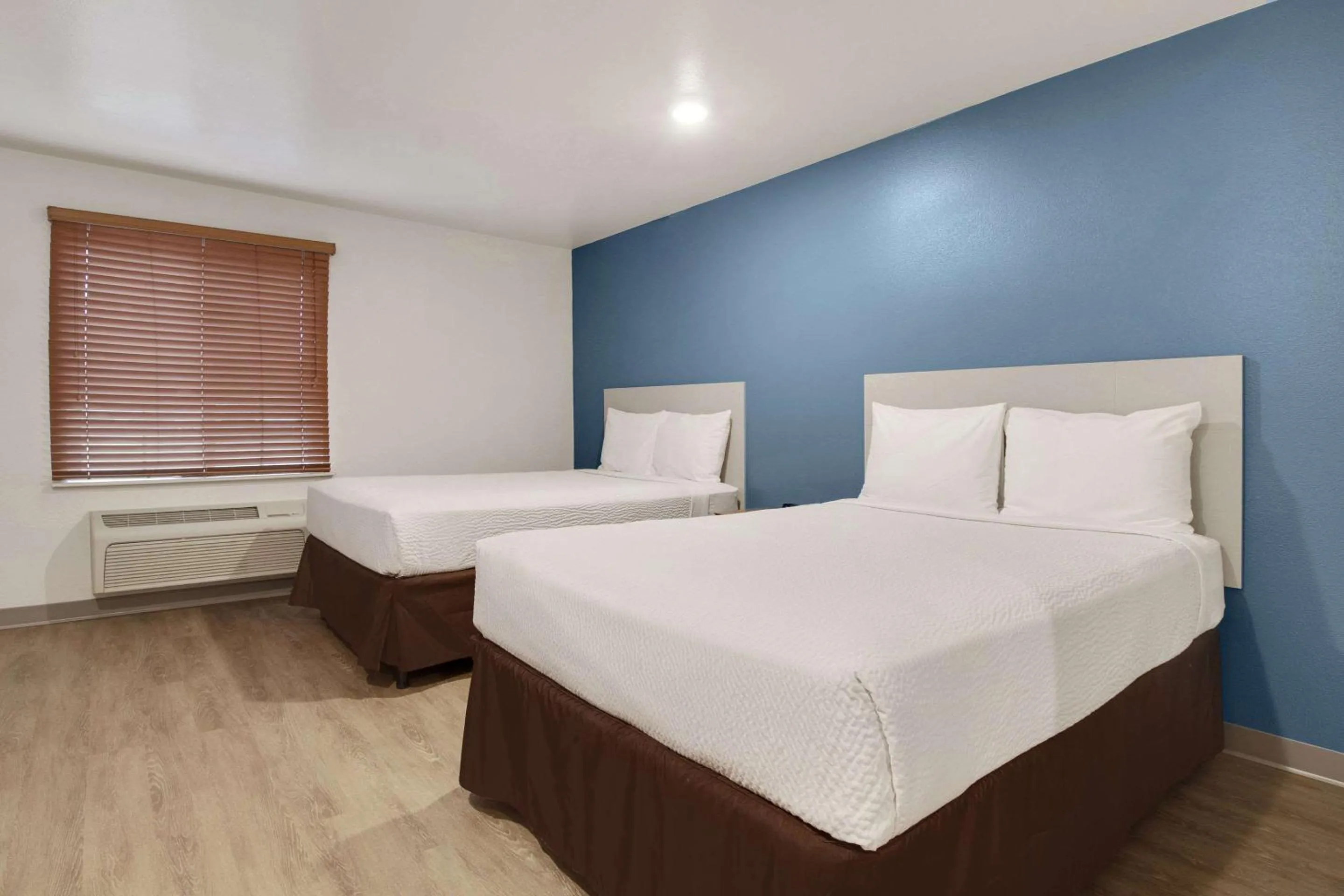 Bedroom, Bed in WoodSpring Suites Conroe