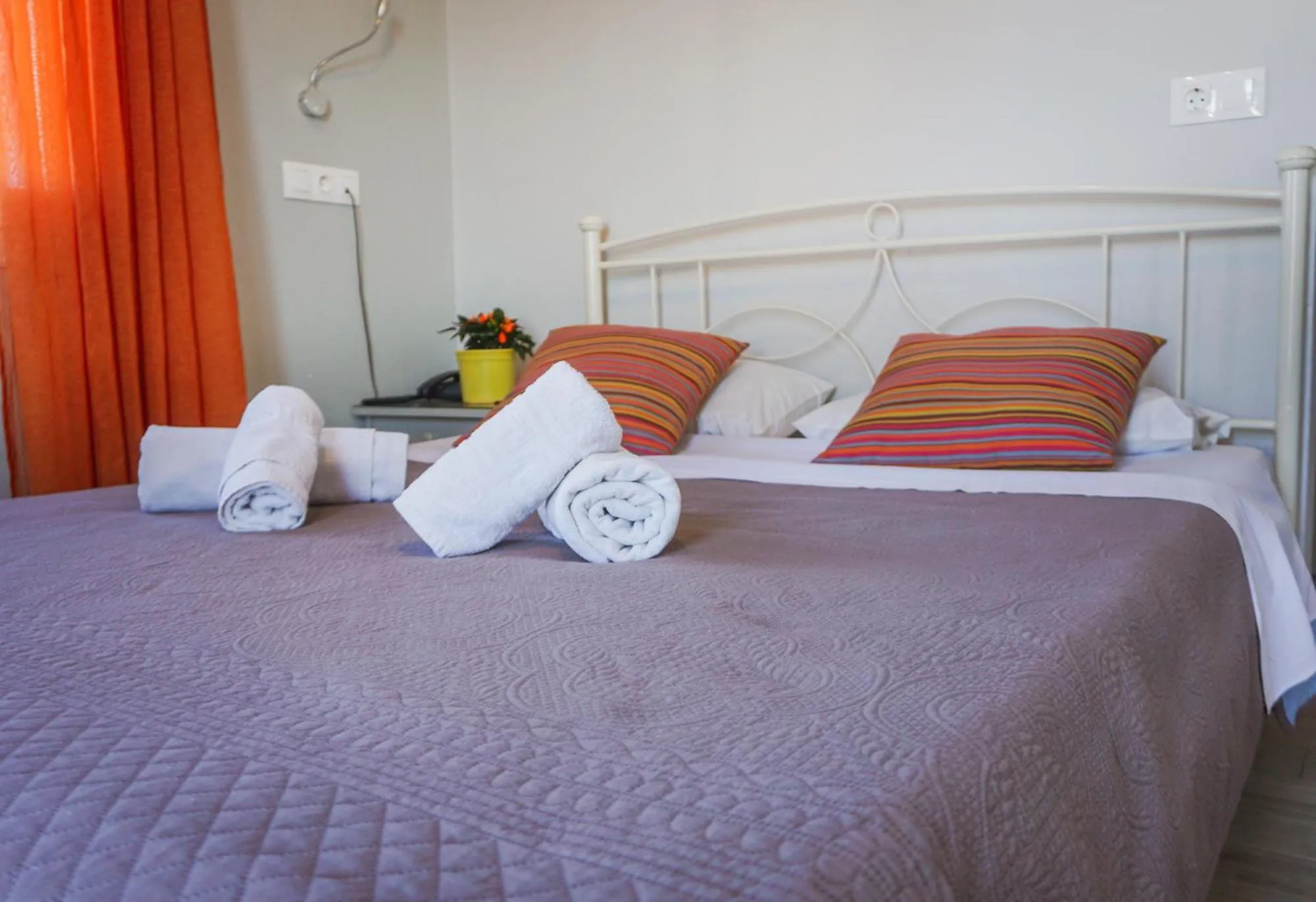 Bed in Aphrodite Art Hotel Aegina