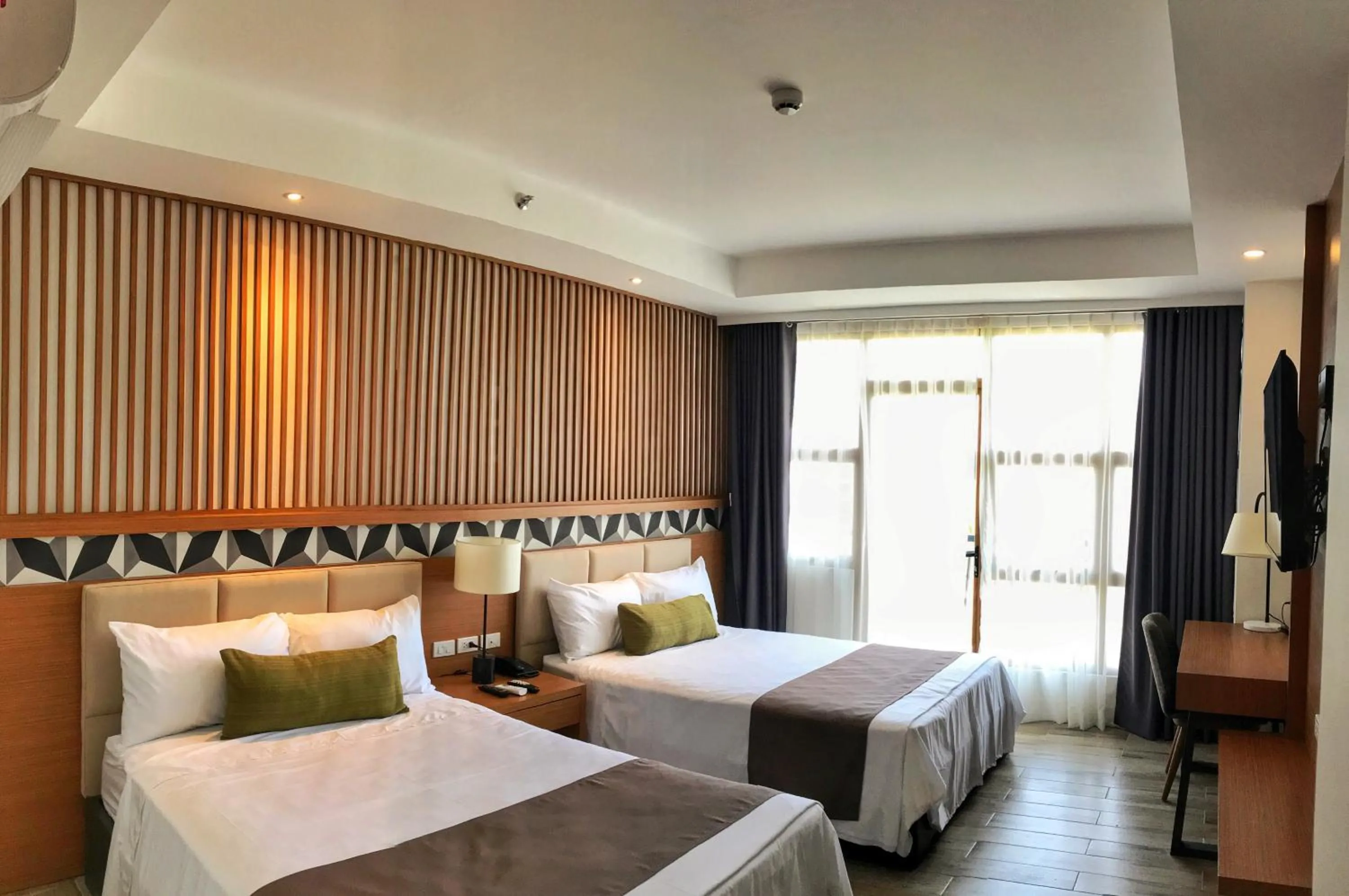 Photo of the whole room, Bed in Crown Hotel at Harbour Springs Palawan Managed by Enderun Hotels