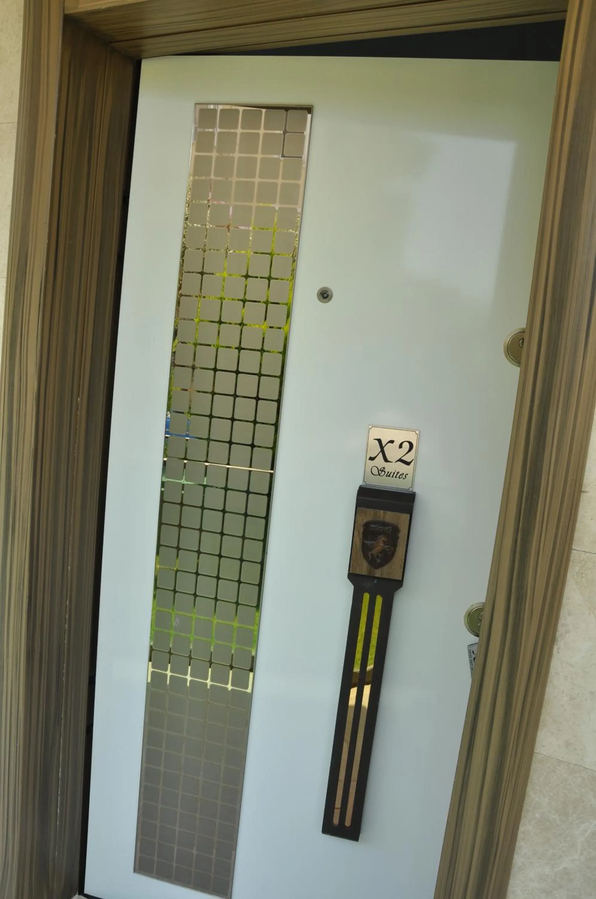 Property logo or sign in X SUITE APART