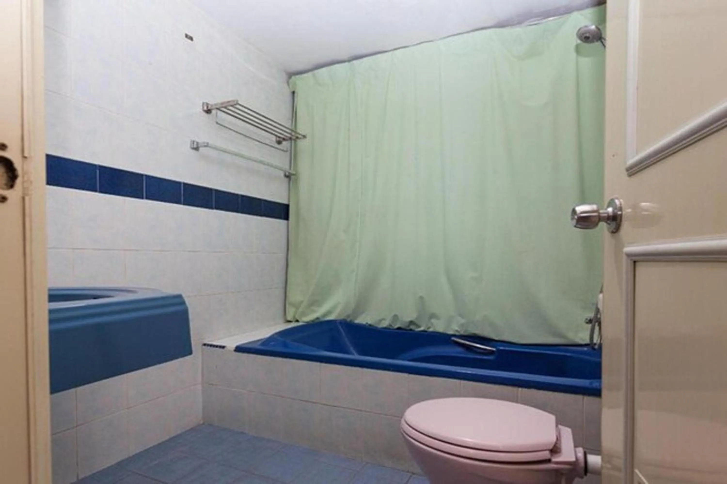 Toilet, Bed in T P Hotel