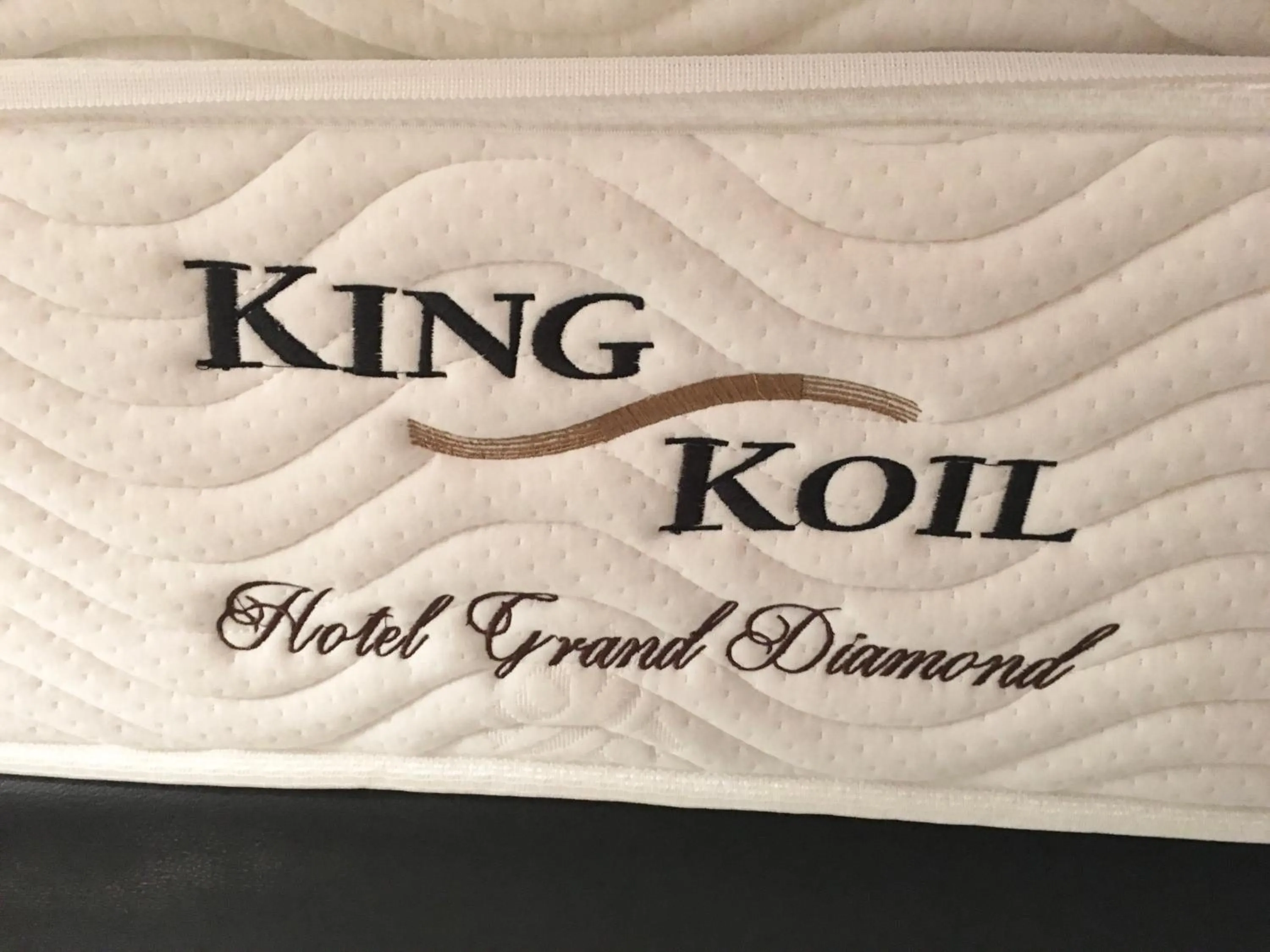 Bed in Nagomi Suites & Hotel