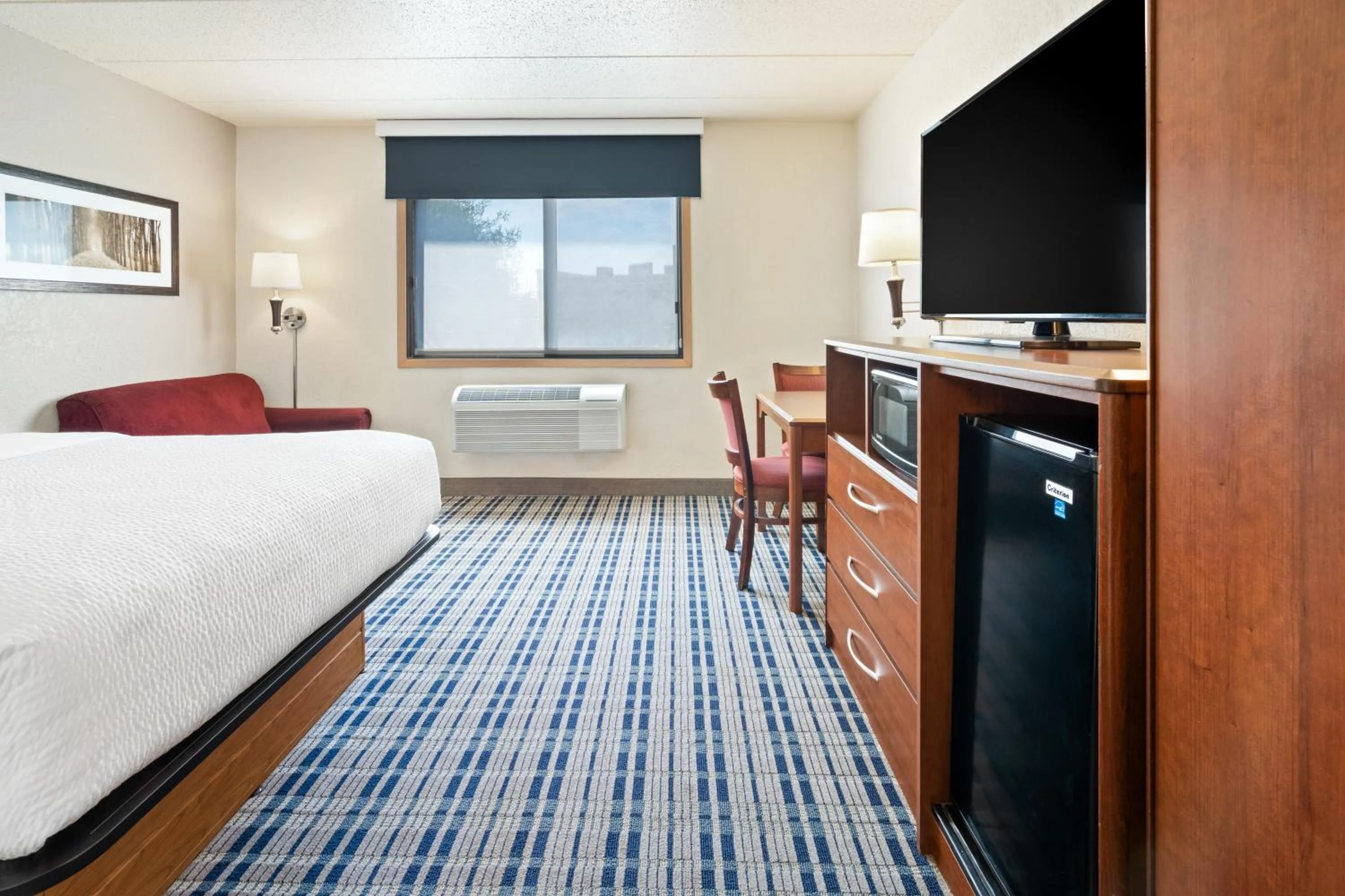 Bed in AmericInn by Wyndham Dickinson