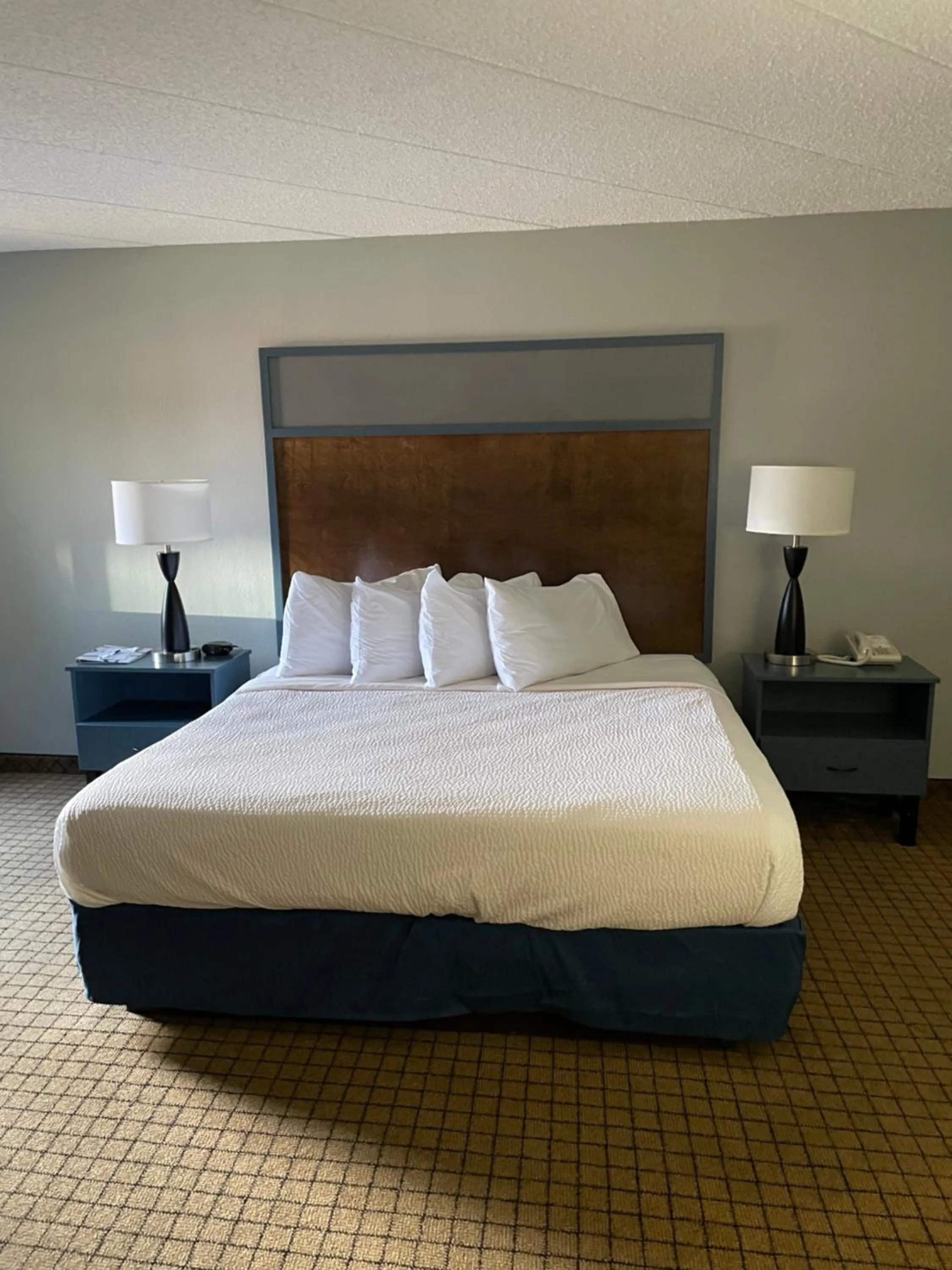Bed in AmericInn by Wyndham Hartford WI