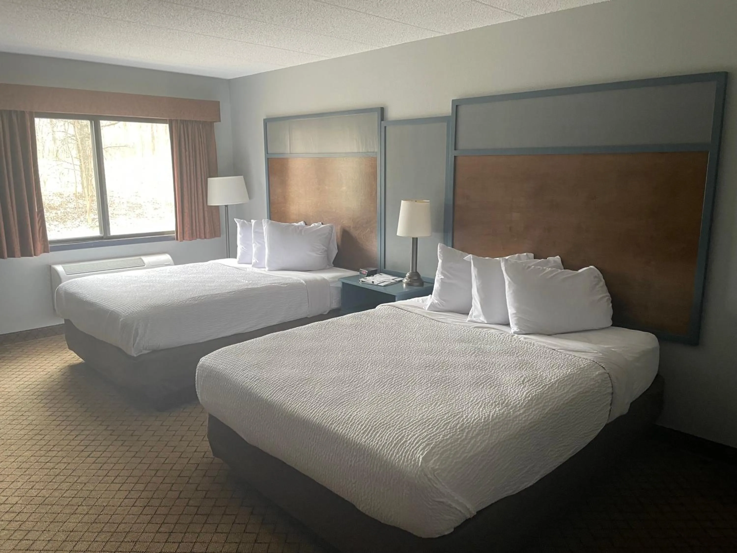 Bed in AmericInn by Wyndham Hartford WI