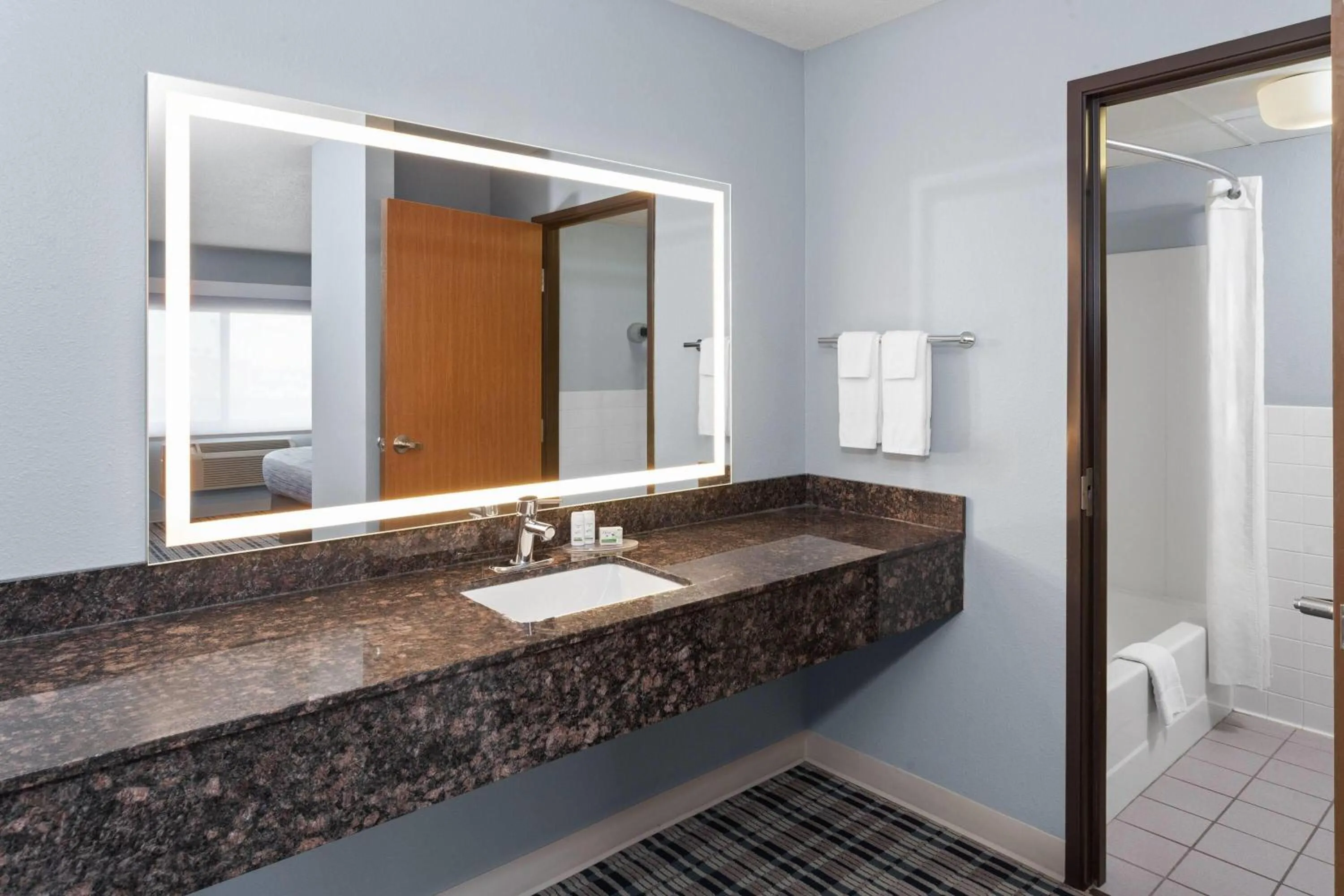 Bathroom in AmericInn by Wyndham West Salem