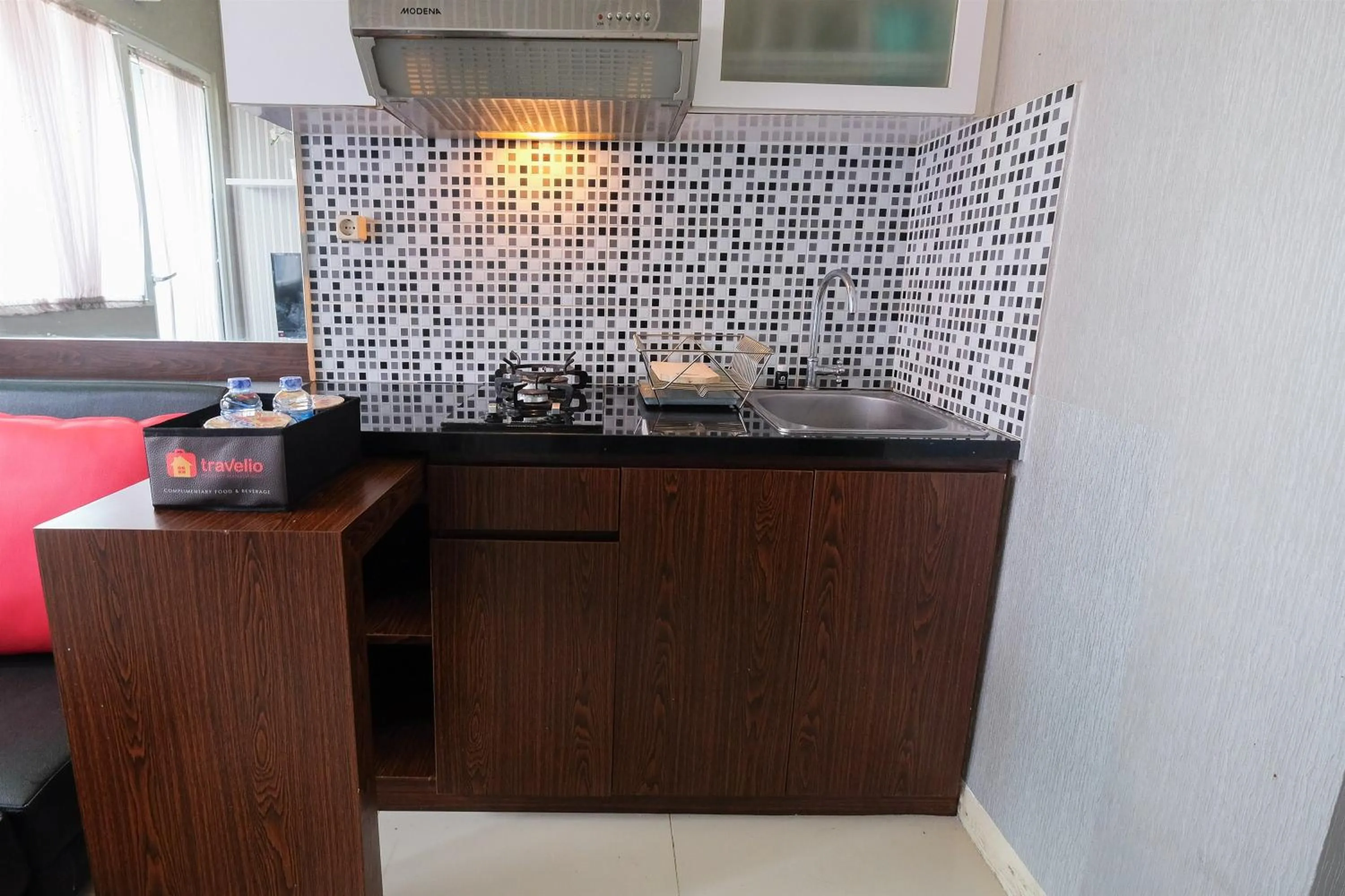 Kitchen or kitchenette in Homey and Relaxing 2BR Green Pramuka City Apartment By Travelio