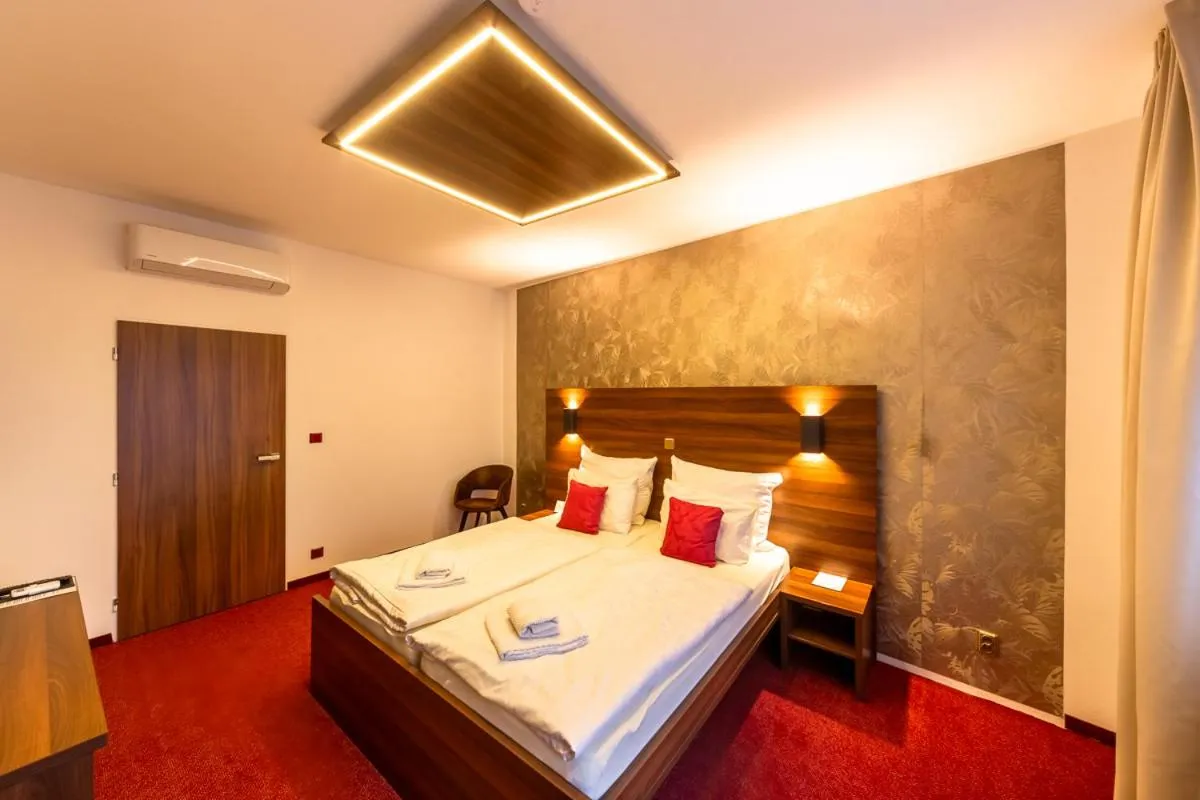 Bed in Bohemia Inn Hotel