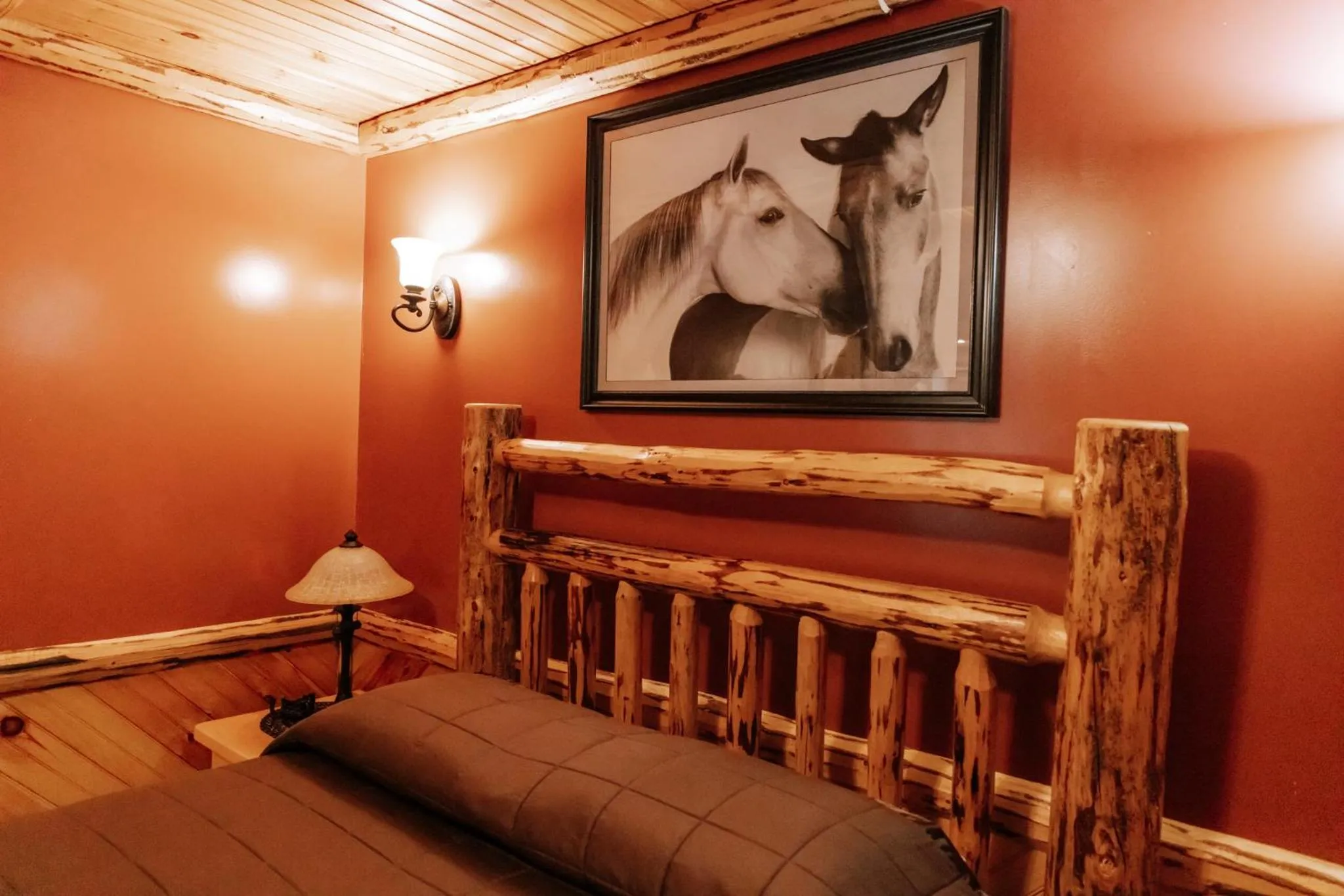 Bed in Sojourner's Lodge & Log Cabin Suites