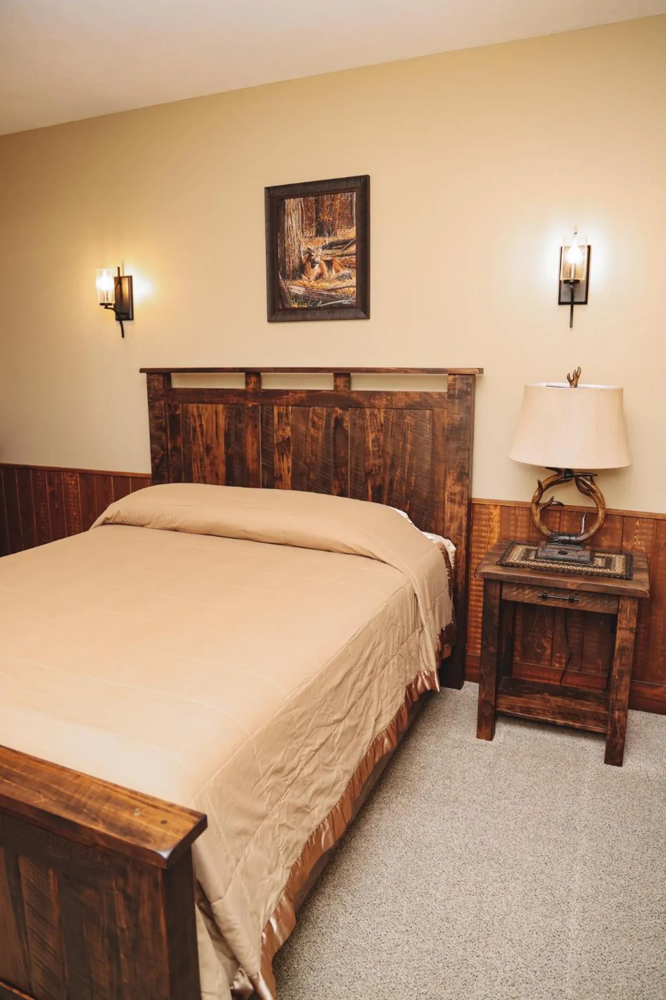 Bed in Sojourner's Lodge & Log Cabin Suites