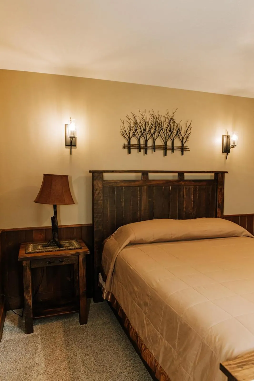 Bed in Sojourner's Lodge & Log Cabin Suites