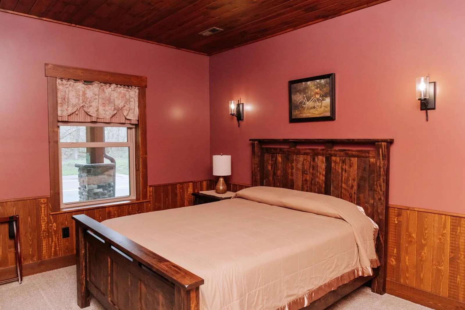 Bed in Sojourner's Lodge & Log Cabin Suites
