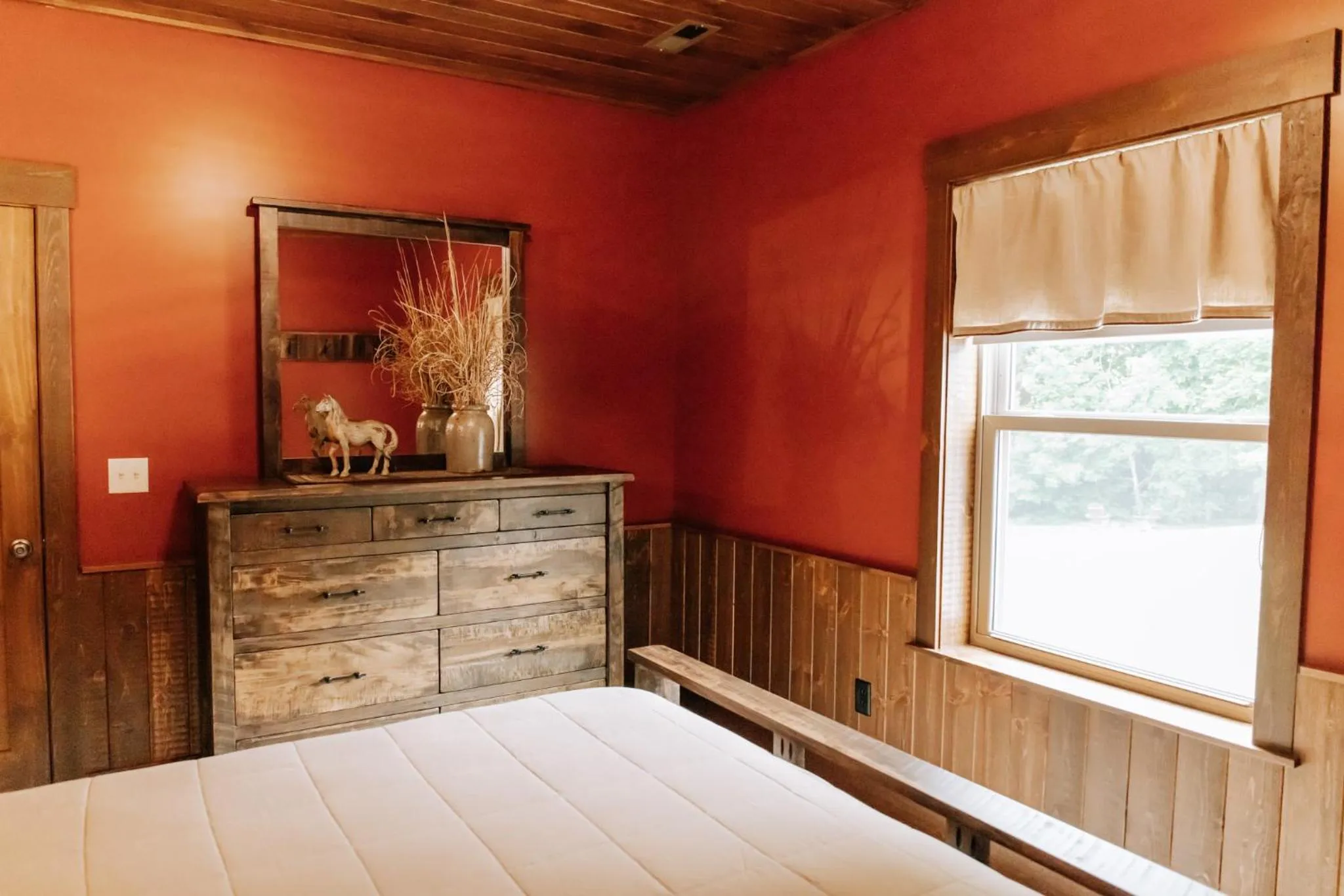 Bed in Sojourner's Lodge & Log Cabin Suites