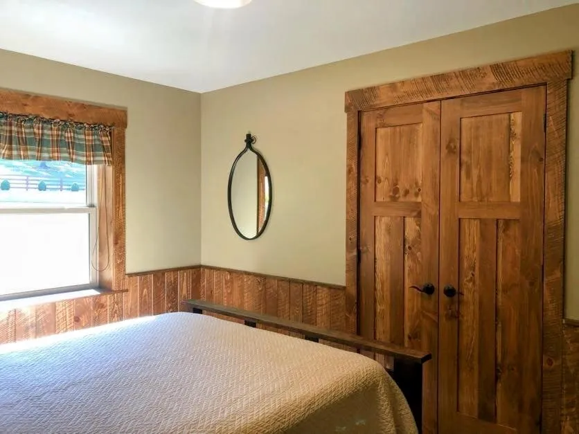 Bed in Sojourner's Lodge & Log Cabin Suites