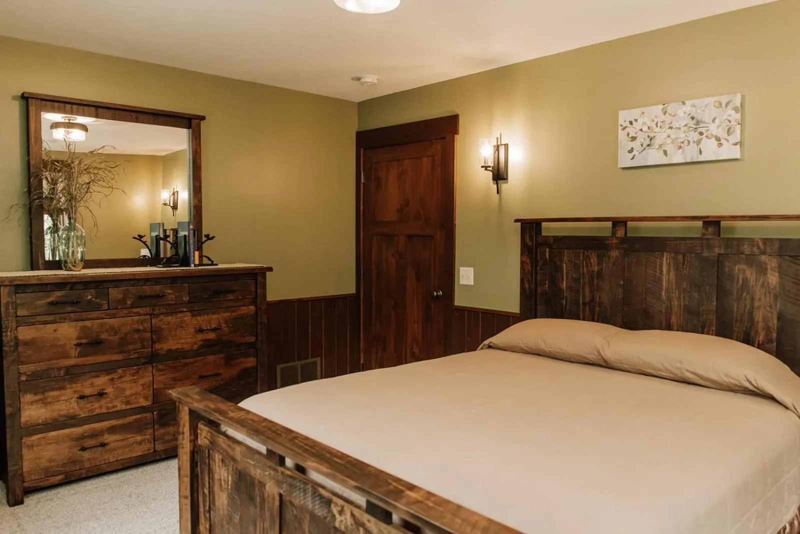 Bed in Sojourner's Lodge & Log Cabin Suites